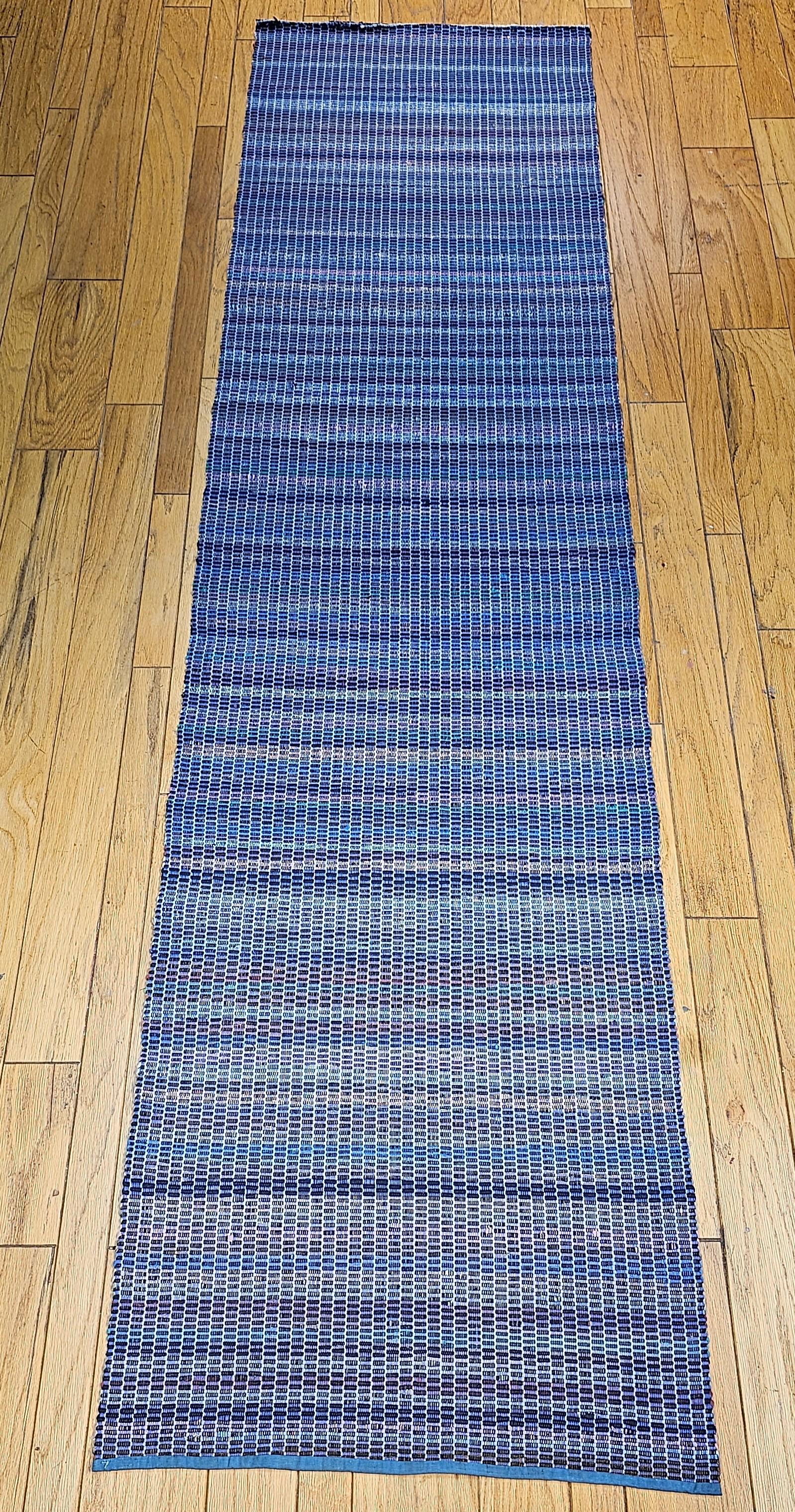 Vintage American Amish Rag Runner is in stripe design and has a very modern design format and can be incorporated into any modern interior design project. This Amish Rag Runner has a striped pattern in denim blue, navy blue, pink, yellow, red, and