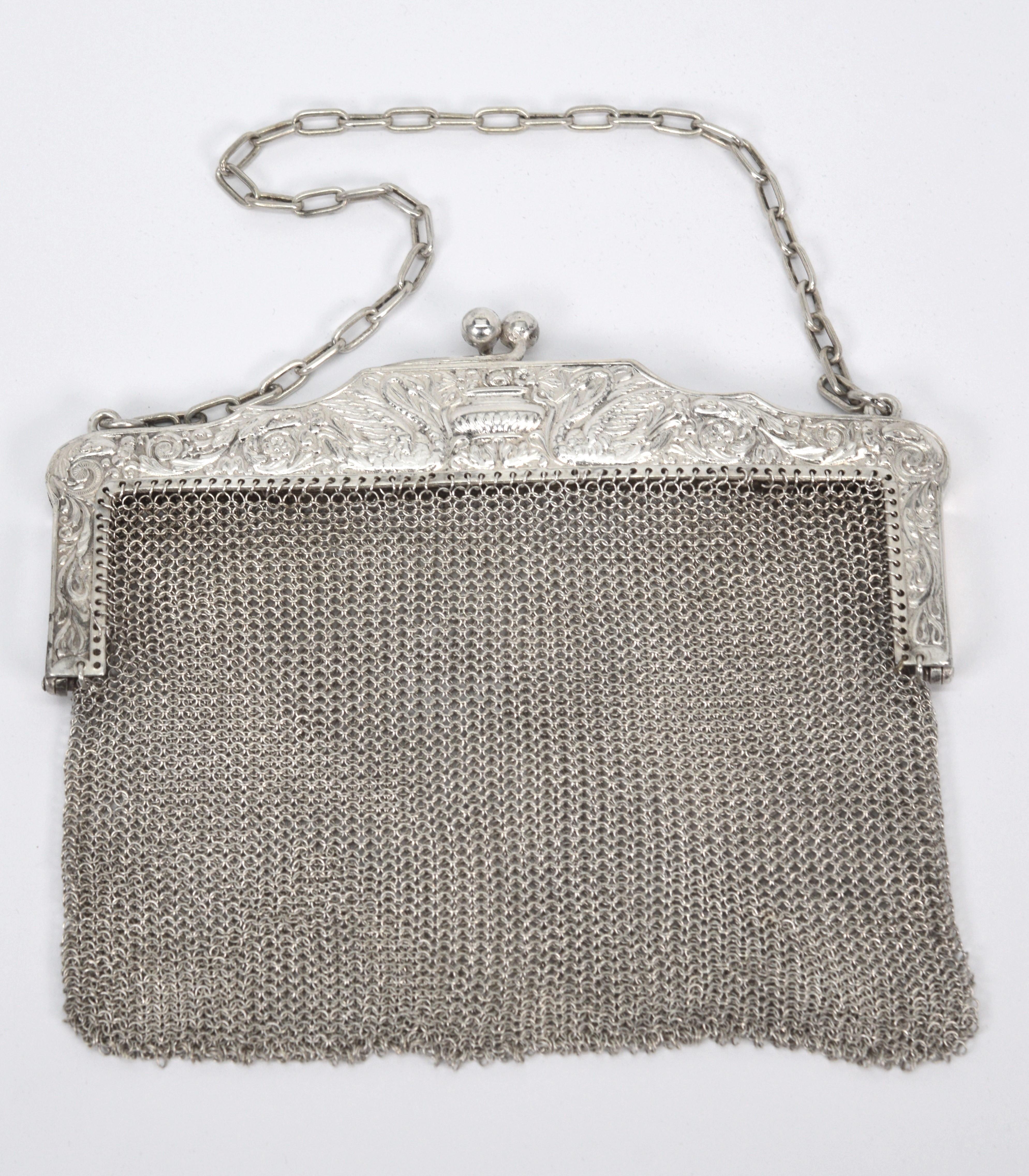 Fabulous vintage accessory for a wedding or special occasion. Circa 1920 American Art Nouveau Ladies evening purse in 870 silver mesh with cable chain handle. Intricate pattern silver with floral and swan details decorate the frame with ball clip