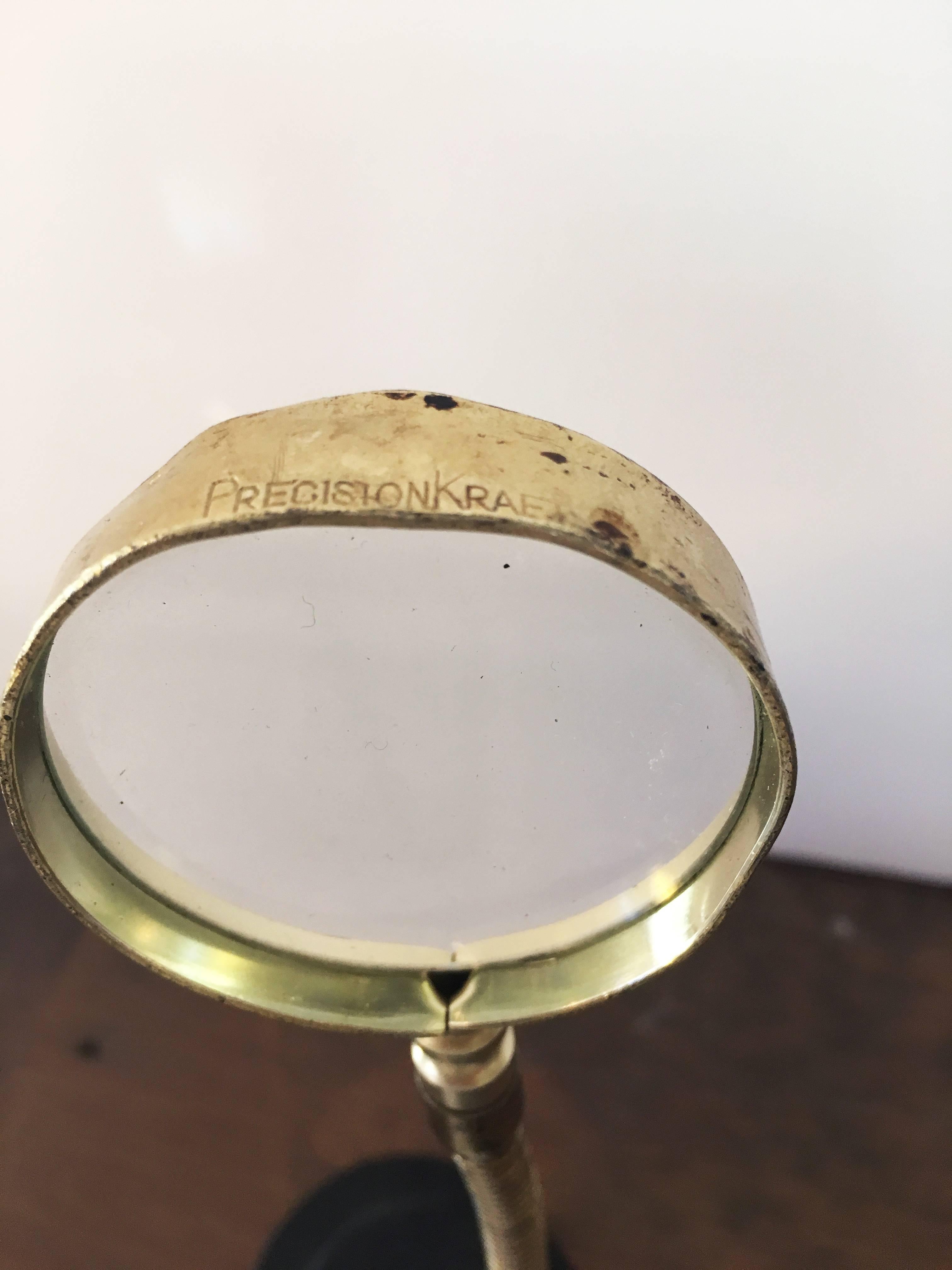 antique brass magnifying glass on stand