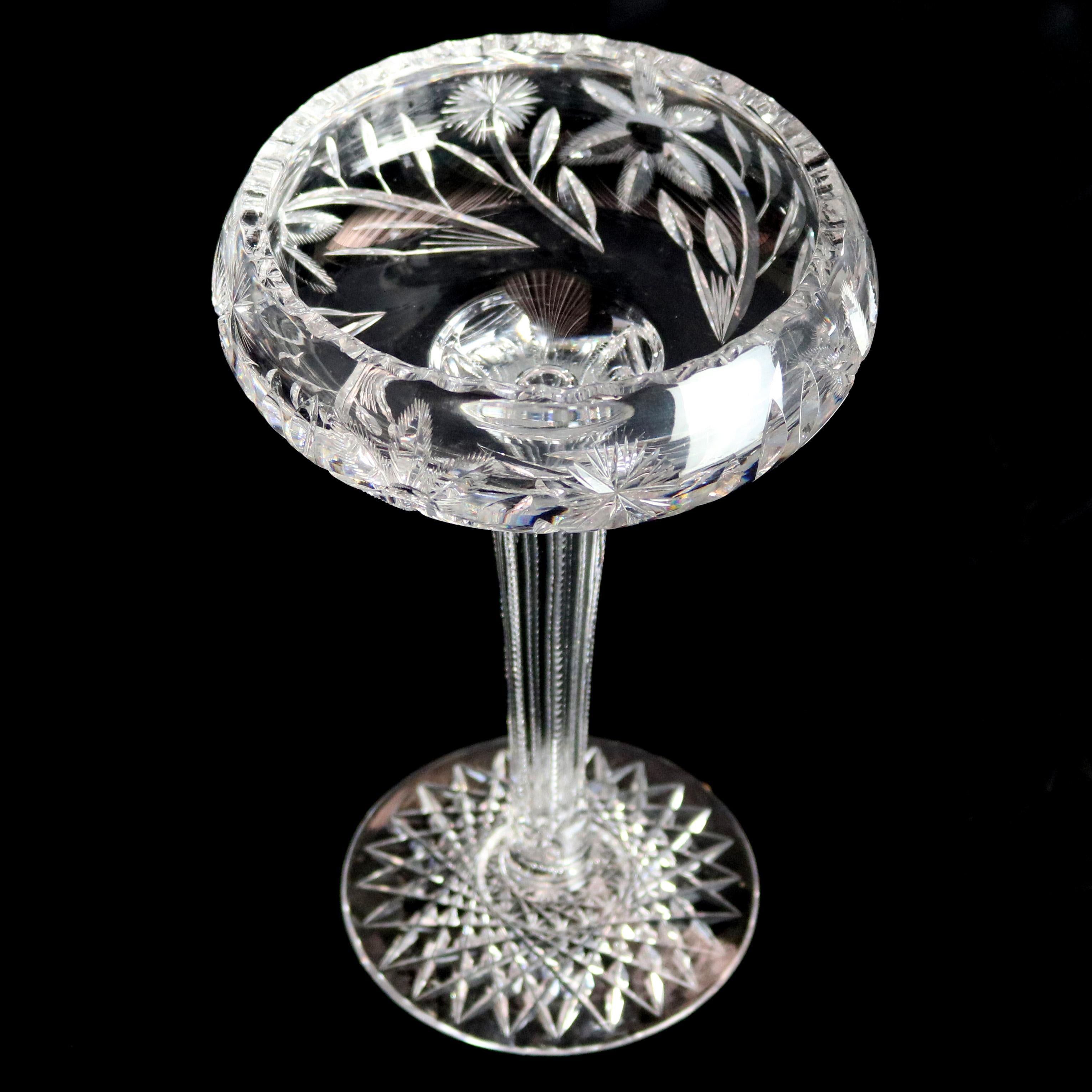 A vintage American brilliant cut glass compote offers bowl with floral design raised on tapered elongated column with diamond cut base, circa 1940.

Measures: 9.25