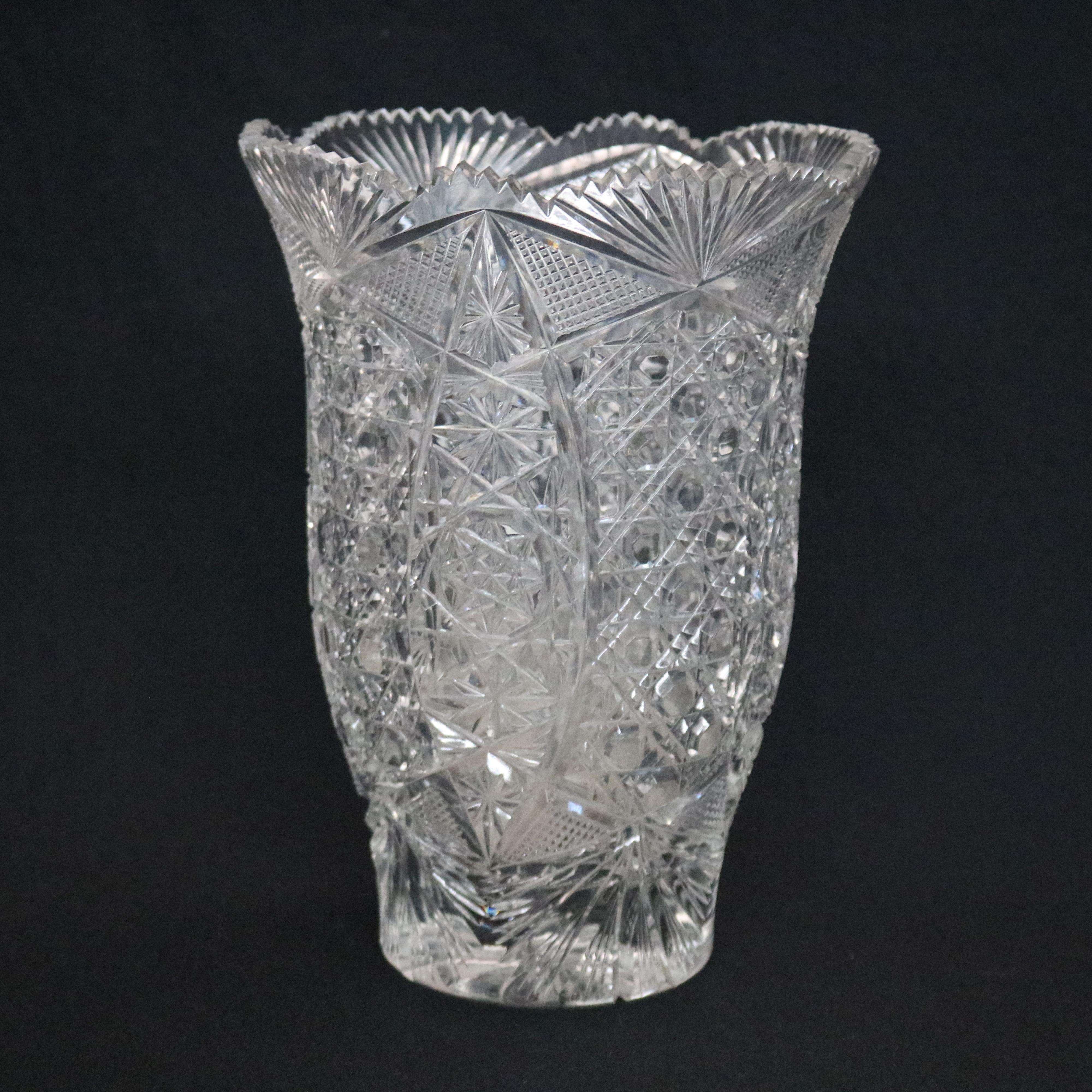 A vintage American brilliant cut glass vase offers flared and scalloped rim with stylized fan design surmounting star floral and diamond patterned vessel, star cut base as photographed, circa 1950

Measures- 11.13