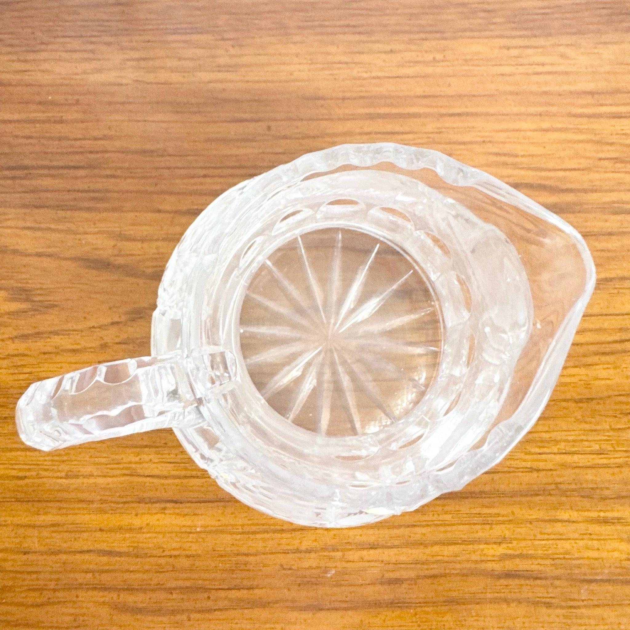 Vintage American Brilliant Pitcher features hand-cut pinwheel and fan patterns, heavy handle, and starburst base—classic crystal elegance for tables.
 

 We sell items as acquired, without restoring or repairing. Vintage pieces may have age-related