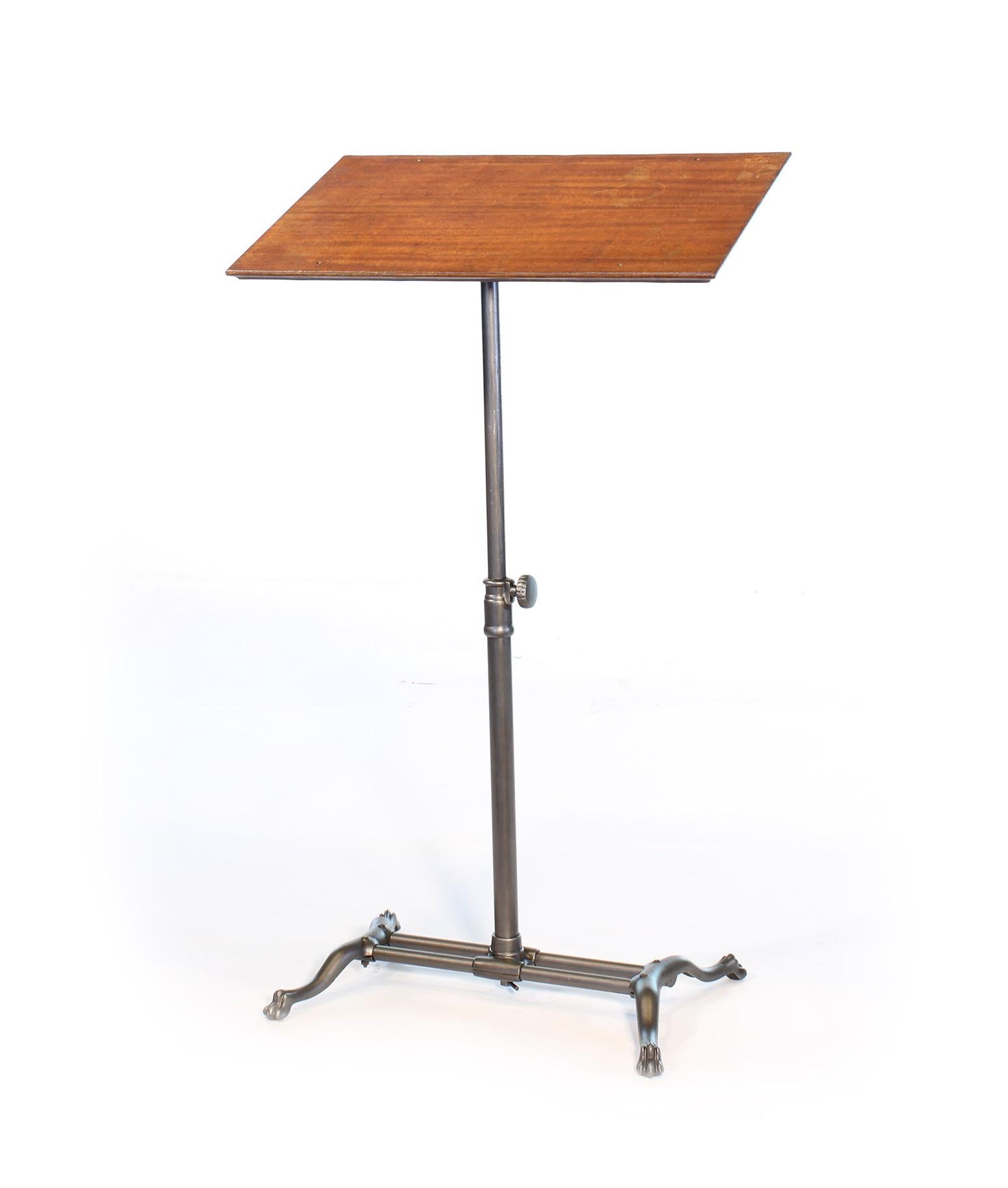 Authentic antique American fully adjustable tilt-top table (hospital bedside table, lectern, podium, music Stand, writing desk). Cast iron with mahogany top and clawfoot base. Mahogany top measures 27