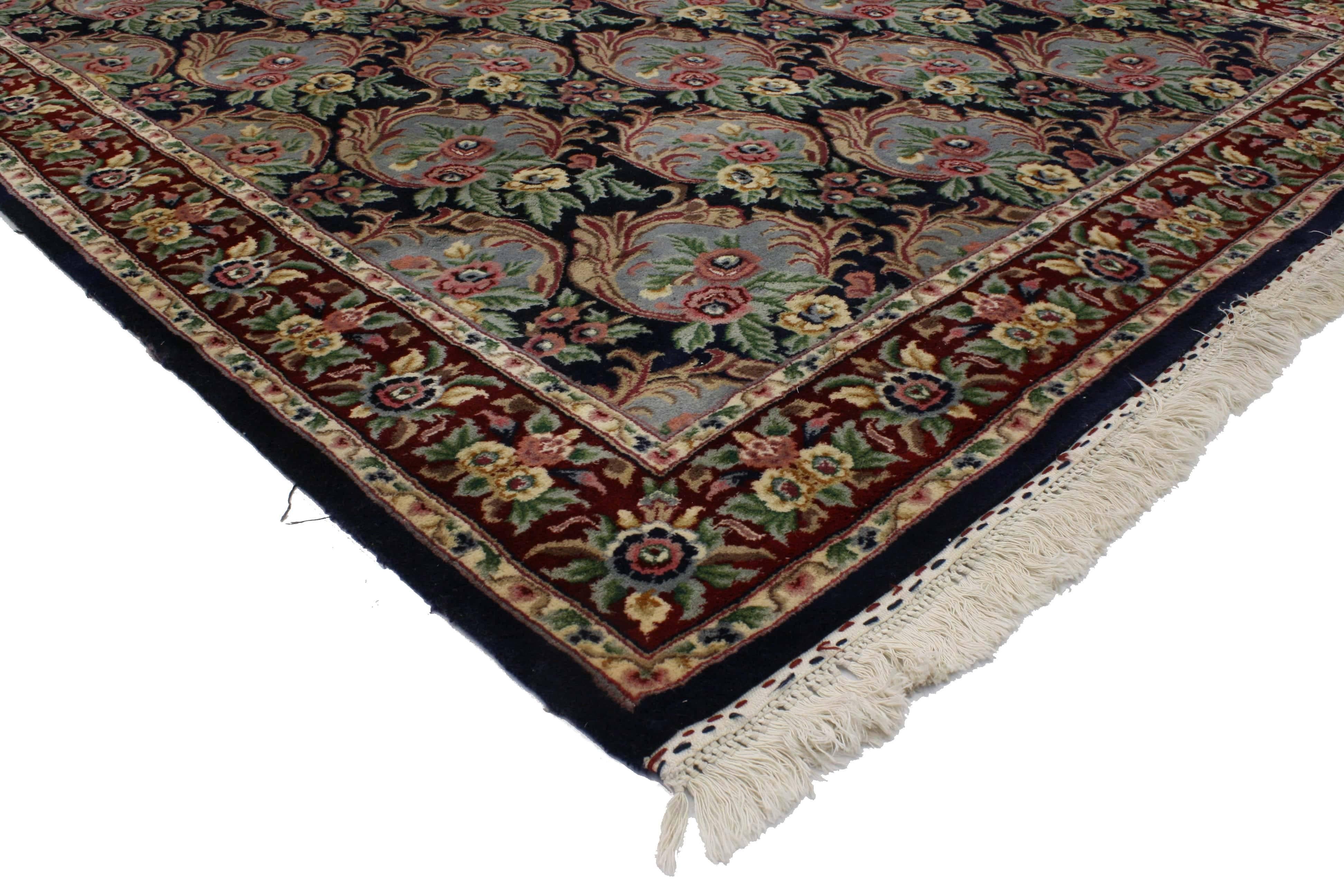 76702, vintage American Colonial style Indian area rug with framed flowers. Delicately arranged flower bunches sit framed by a foliate oval in each pattern that covers the field of this beautiful vintage Indian rug with Colonial style. This vintage