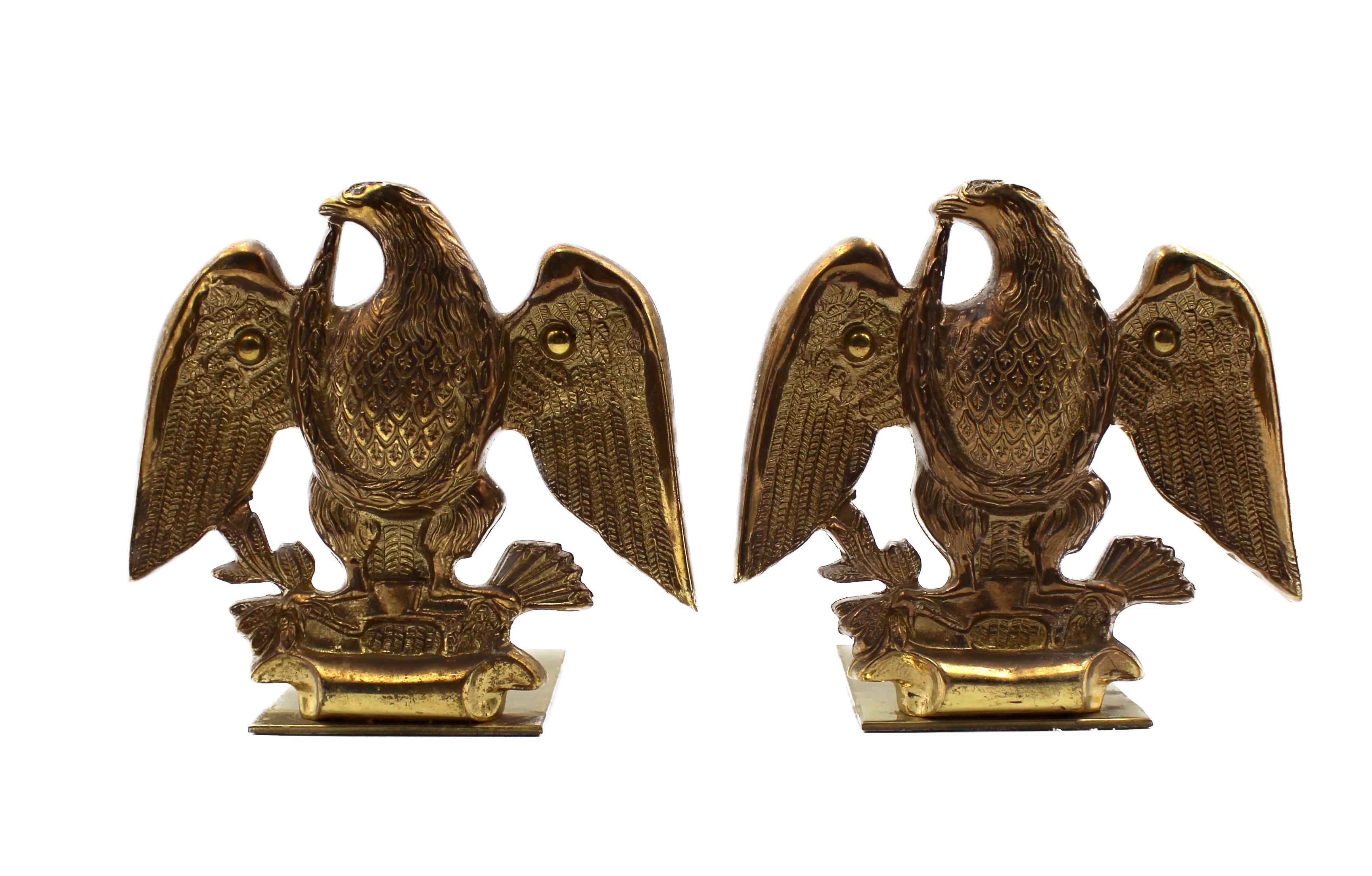Offered is a set of vintage brass eagle bookends. Each bookend depicts a wingspread eagle clutching a bundle of arrows in its left talon and an olive branch in the right talon. When set against books, the base of the bookends slips underneath and