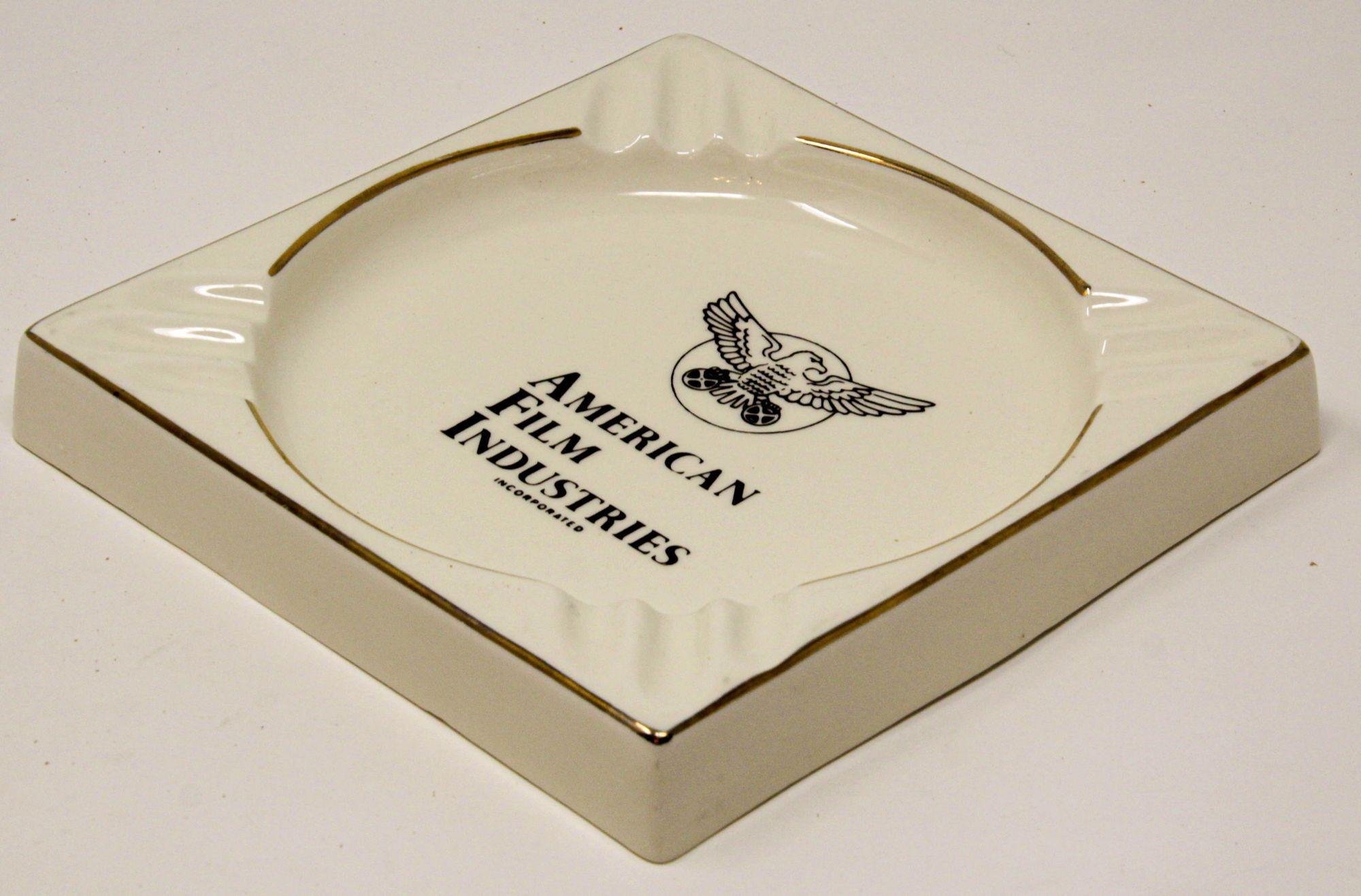 Large vintage American Film Industries Incorporated large ceramic beige ivory and gold ashtray.
Vintage American film industries incorporated large sized ashtray.
Art Deco style large square cigar ashtray in high gloss finish cream ivory color
