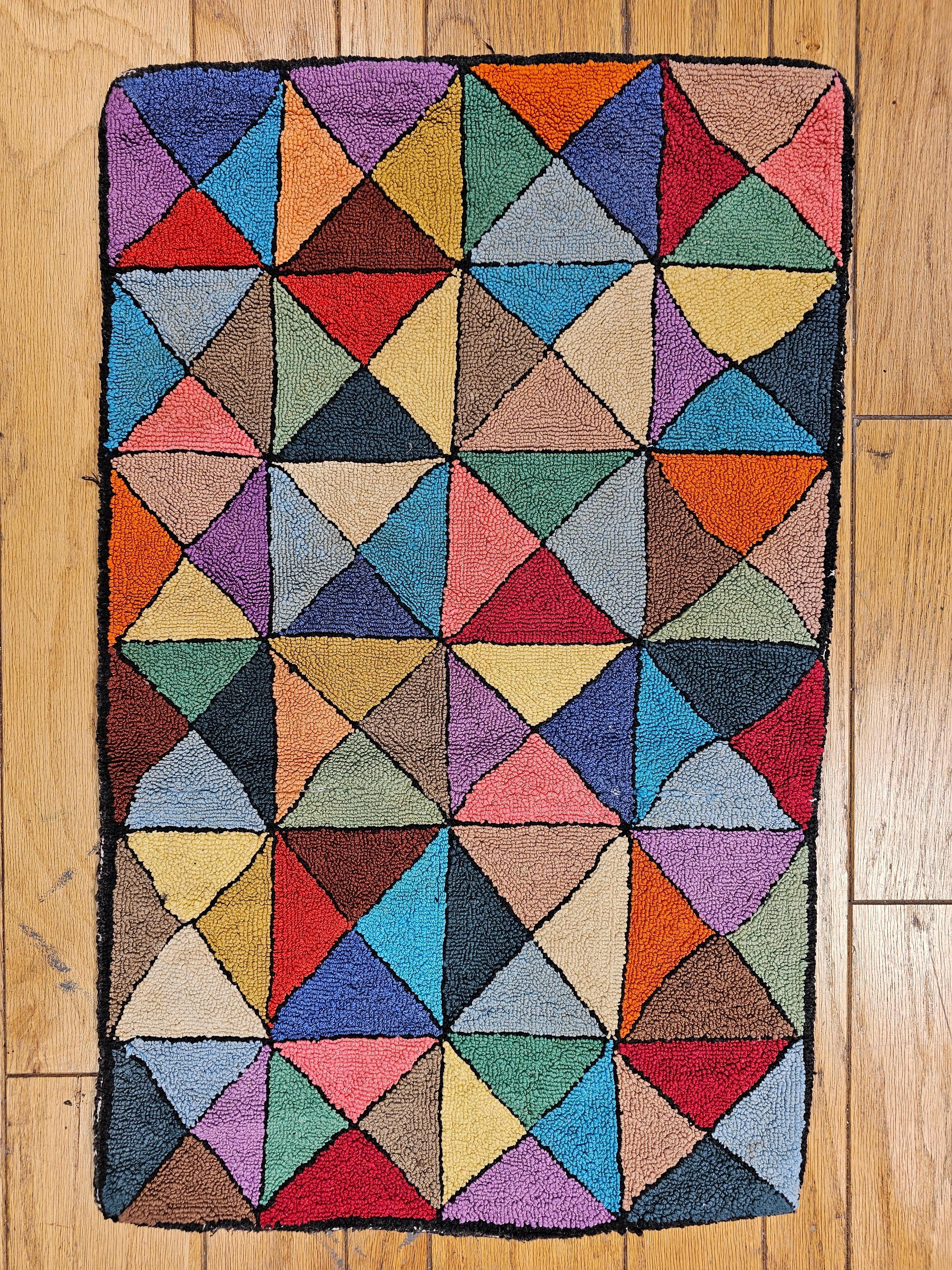 Vintage American hand hooked rug in a stripe pattern handcrafted in the 2nd quarter of the 1900s.  The hand hooked rug is in a multicolor block pattern in various brilliant colors.  The  hooked rugs from the late 19th and early 20th centuries are