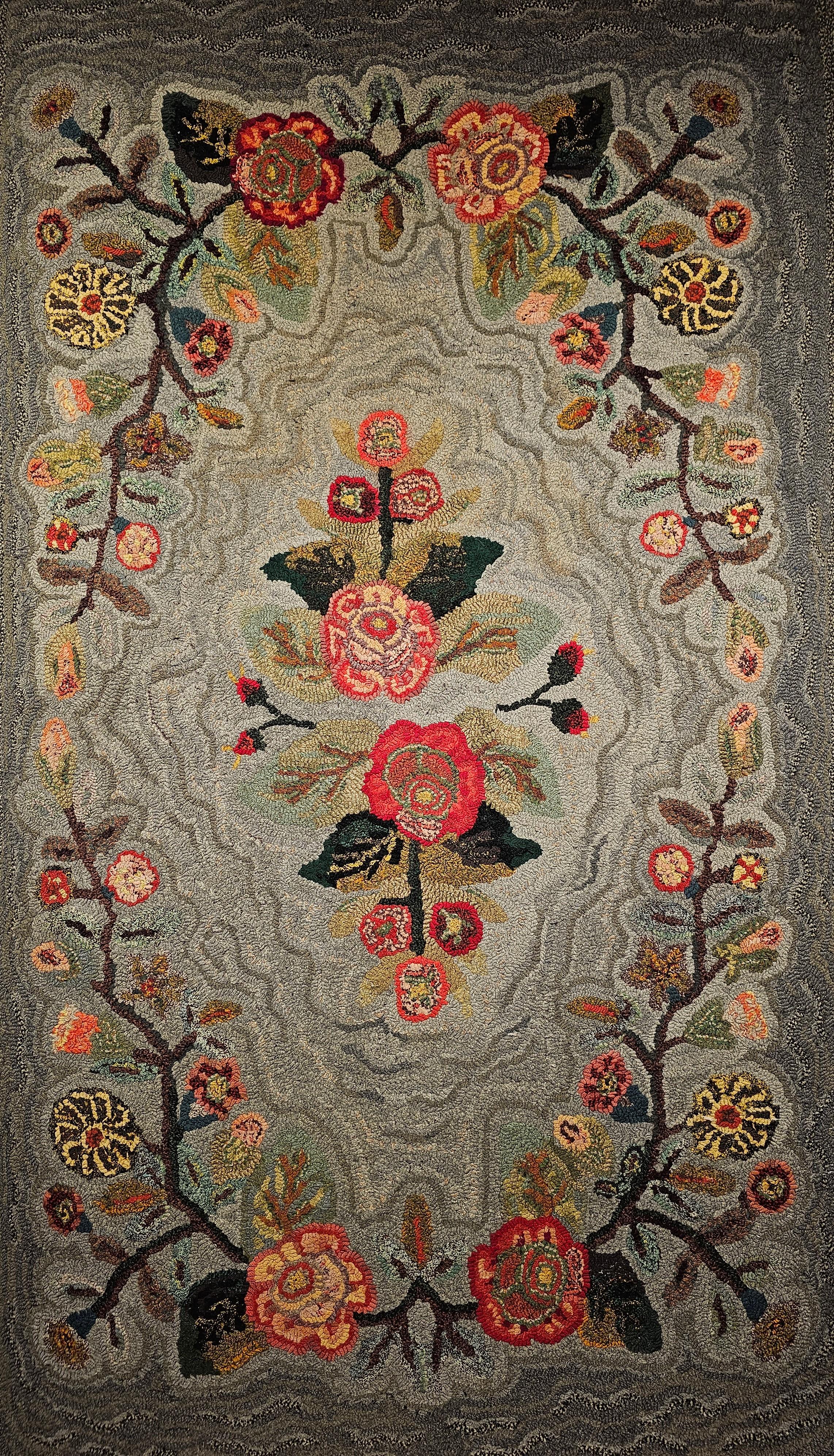 Vintage American Hand Hooked Rug from the mid 1900s in a floral pattern in pale blue and grey background with floral design in red, pink and green. The use of special design and the brilliant colors brings beauty to any space and design it is