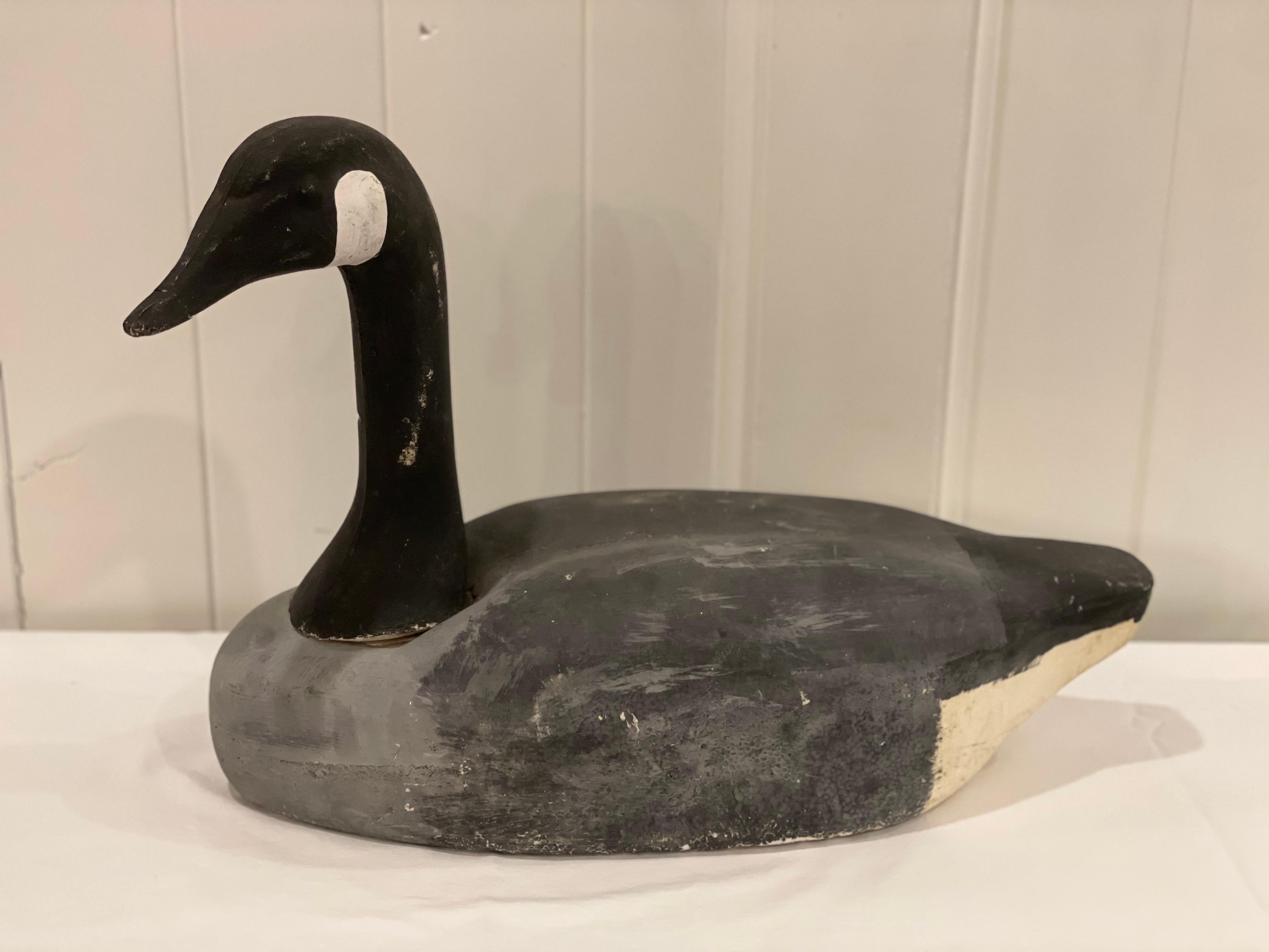 Vintage American Hand Painted Long Neck Goose Decoy. This gorgeous decoy has original paint and has seen many birds dropped over it, hence the great character it has. This goose decoy from Decoys Unlimited constructed in Clinton Iowa. Original