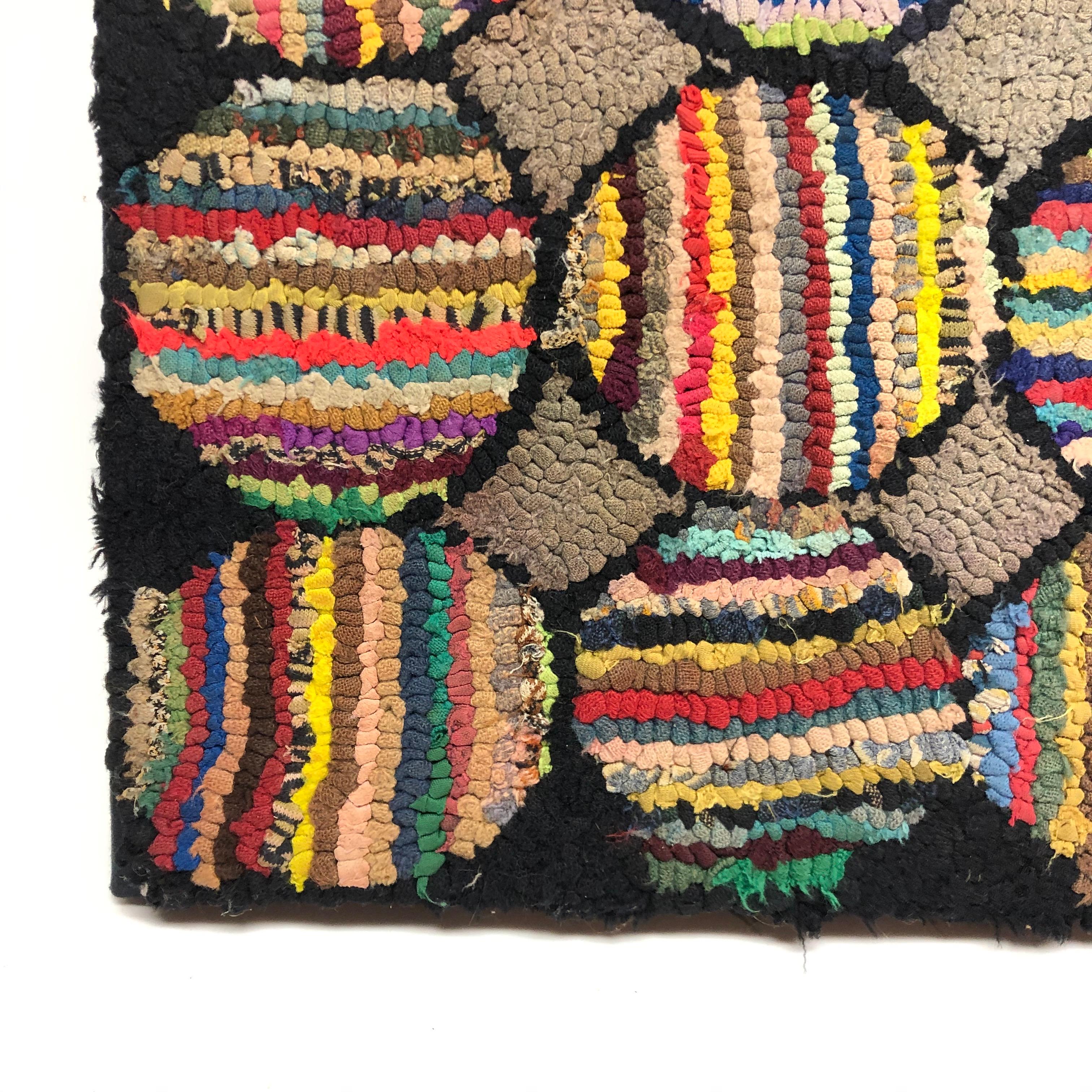 Folk Art hook rug mounted on board for wall display but could easily detach for floor use. Unusual pattern feels modern.