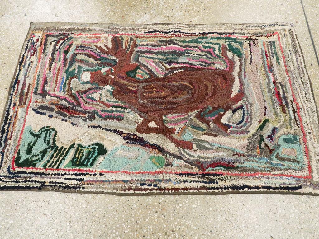 A vintage American Hook rug from the mid-20th century. A manic stag energetically bounds to the left across a striated, snowy landscape in this vintage rug. The eccentric effect is accentuated by the short strips of rag employed, giving a vibrant