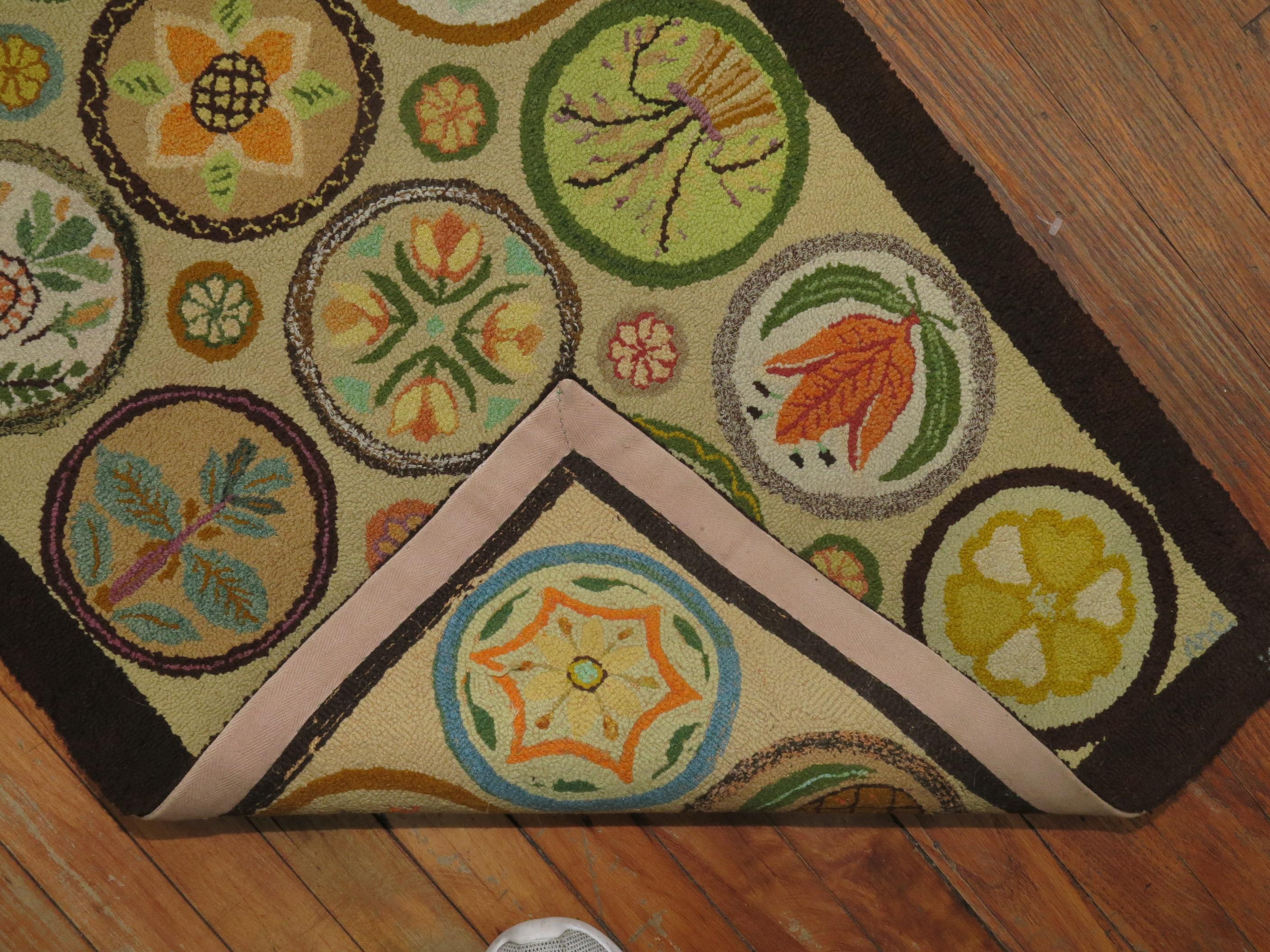 An American hooked rug dated 1980 with a colorful multiple circular design featuring different fruits, animals and plants.

Measures: 2' x 3'2''.