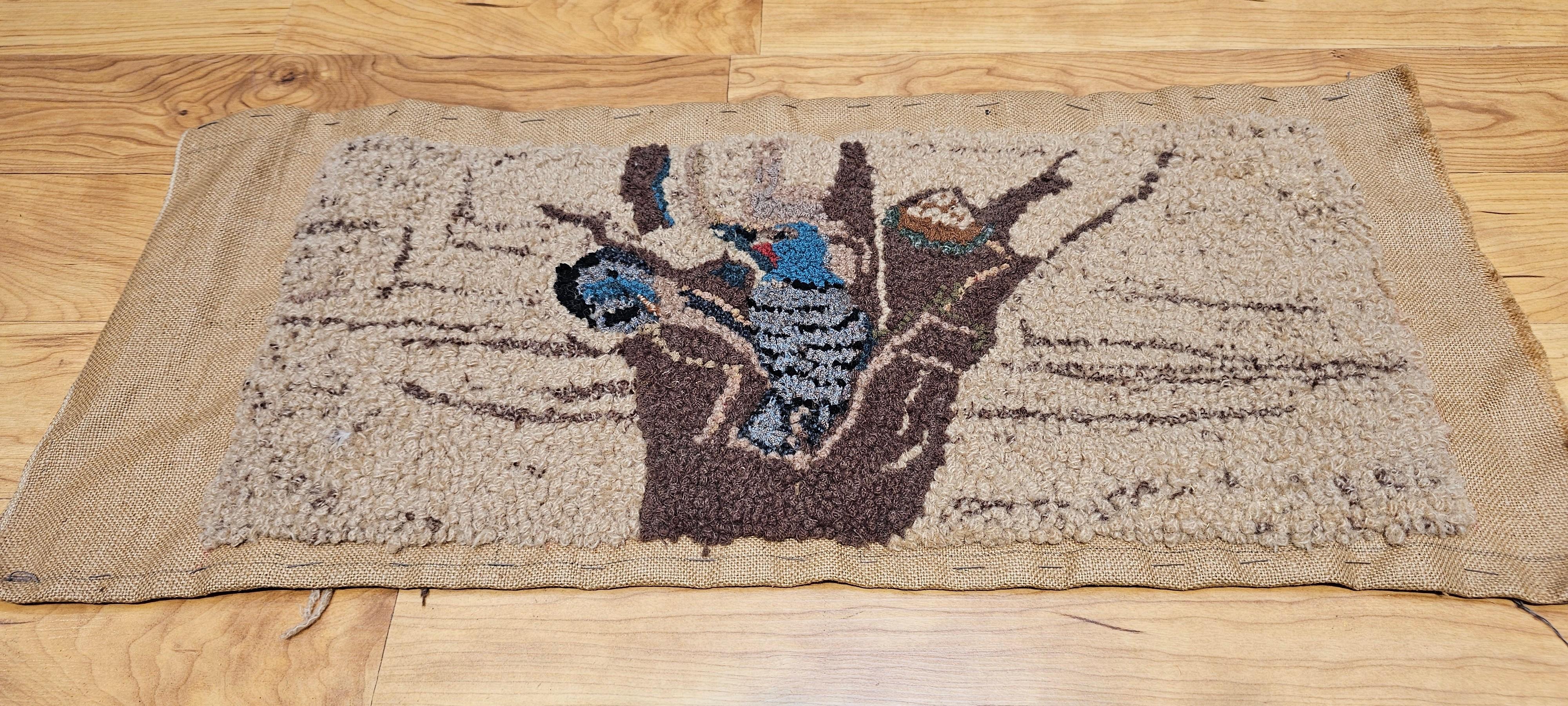 Vintage American hand hooked rug in a wonderful depiction of birds in a tree nest.  The rug has a delightful design and colors including brown, khaki, blue, and lavender.  Looking closely, you can see a mother bird trying to feed her chick in the