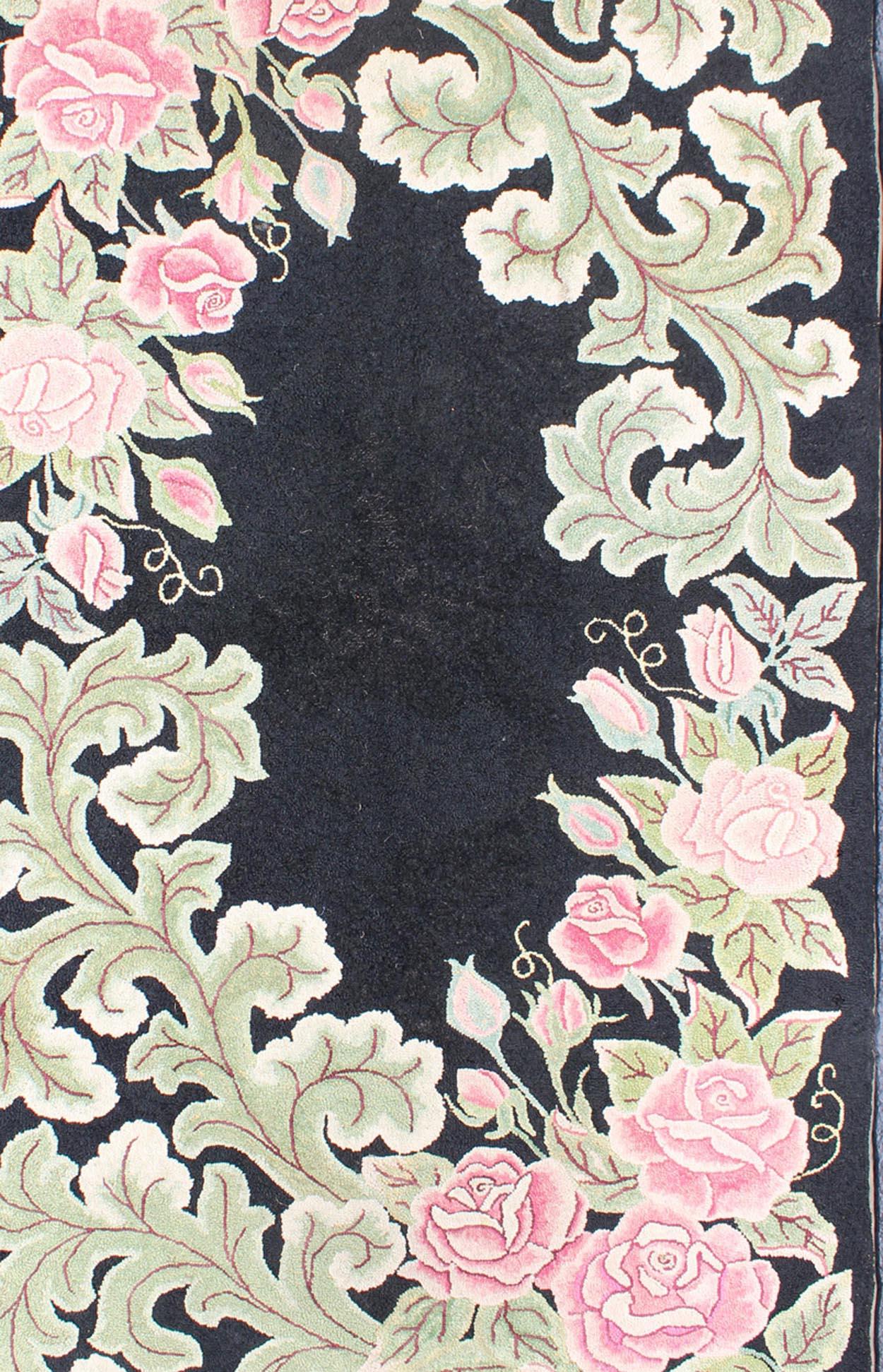 American hooked rug in black background. This beautiful antique American Hook rug sets on black background with large floral medallion. American hooked rug , Keivan Woven Arts/rug/L11-0605, country of origin / type: United States / Hooked, circa