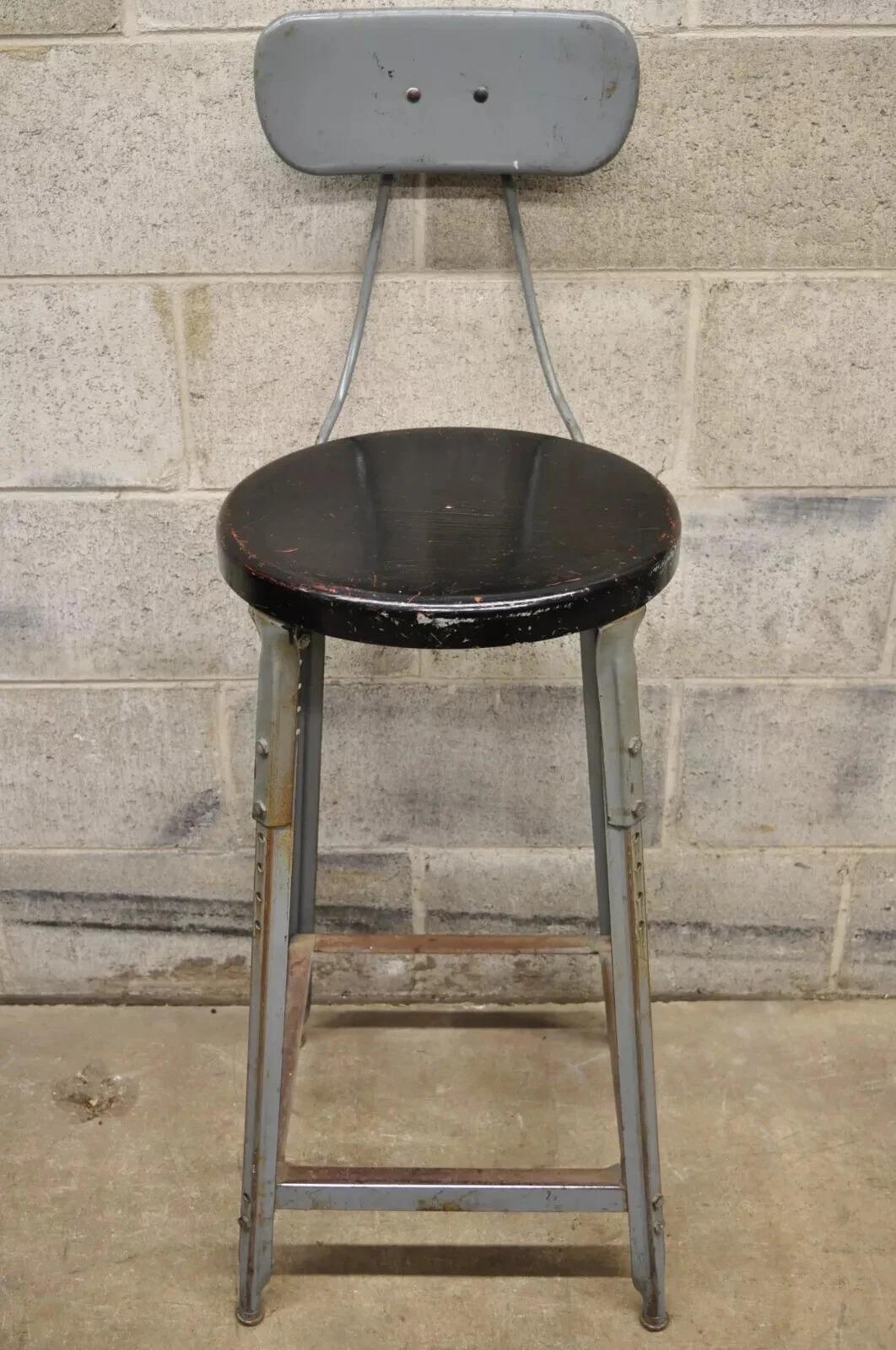 Vintage American Industrial Gray Metal Drafting Stool Artist Work Chair. Item features adjustable height, black painted metal round seat, metal frame, distressed finish, very nice vintage item, quality American craftsmanship. Circa Mid 20th Century.