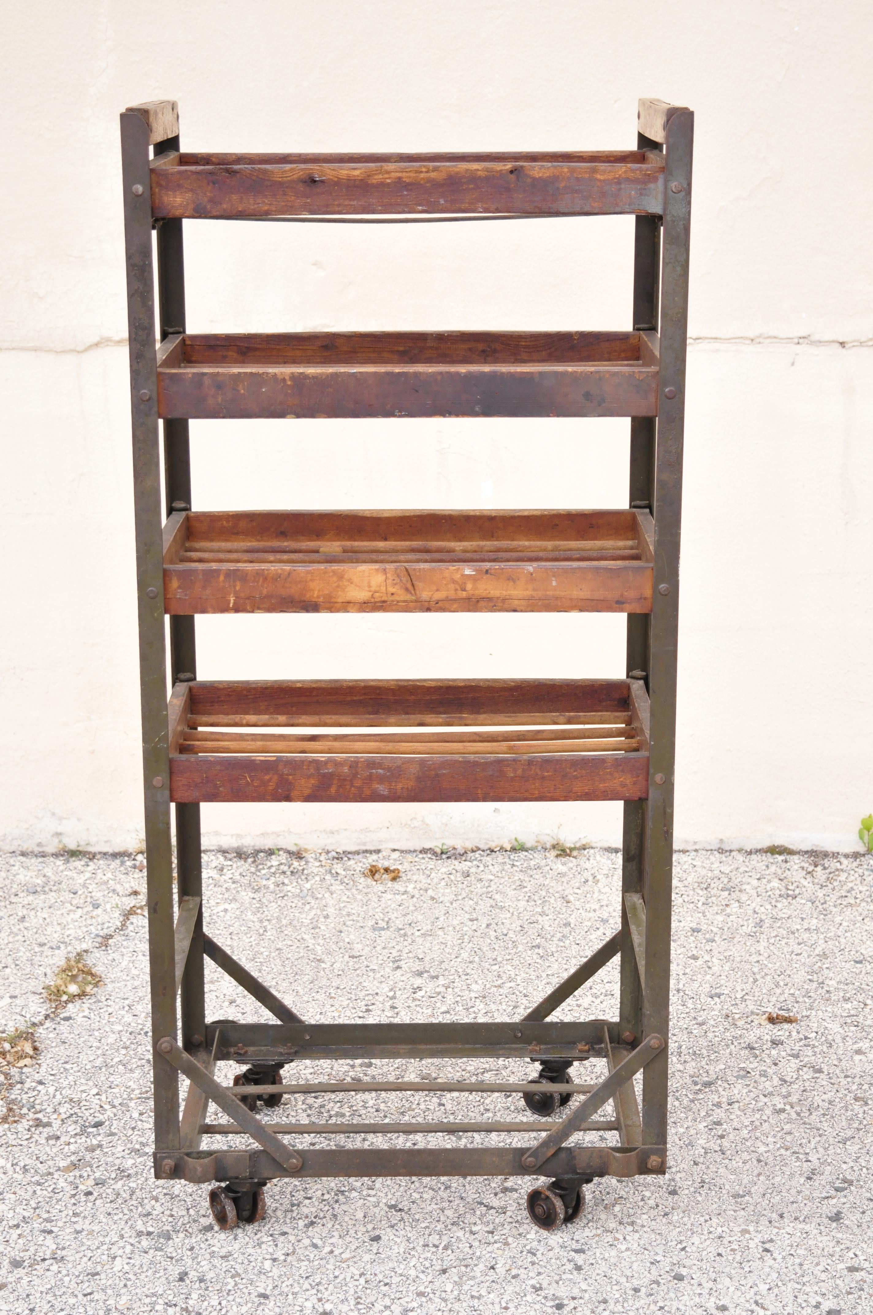 Vintage American industrial steel metal and wood rolling shop work cart stand. Item features wood and iron construction, rolling caster wheels, distressed finish, very nice vintage item, quality craftsmanship. Circa early to mid 1900s. Measurements: