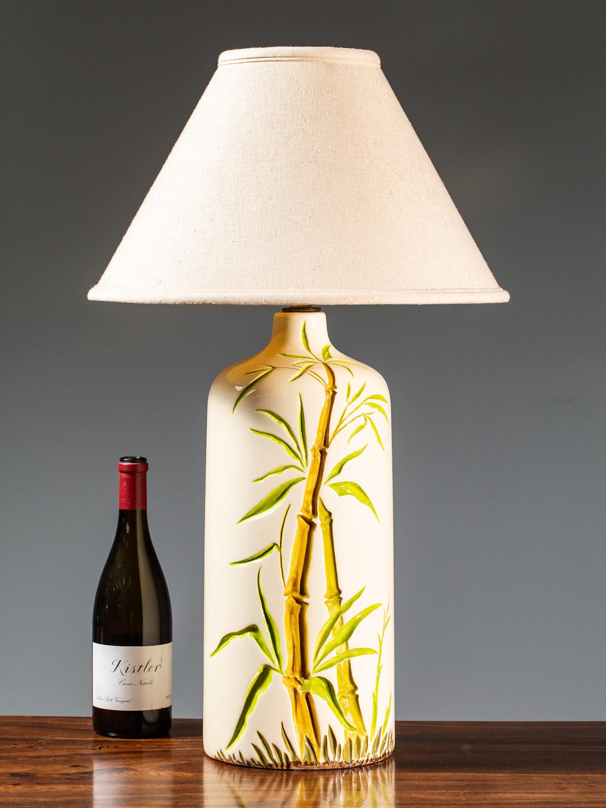 The fabulous scale and the hand painted details on this vintage American lamp feature a handsome pattern of exotic bamboo circa 1960. Definitely reminiscent of evocative Tiki Polynesian deciration which swept the US this vintage lamp has real style.