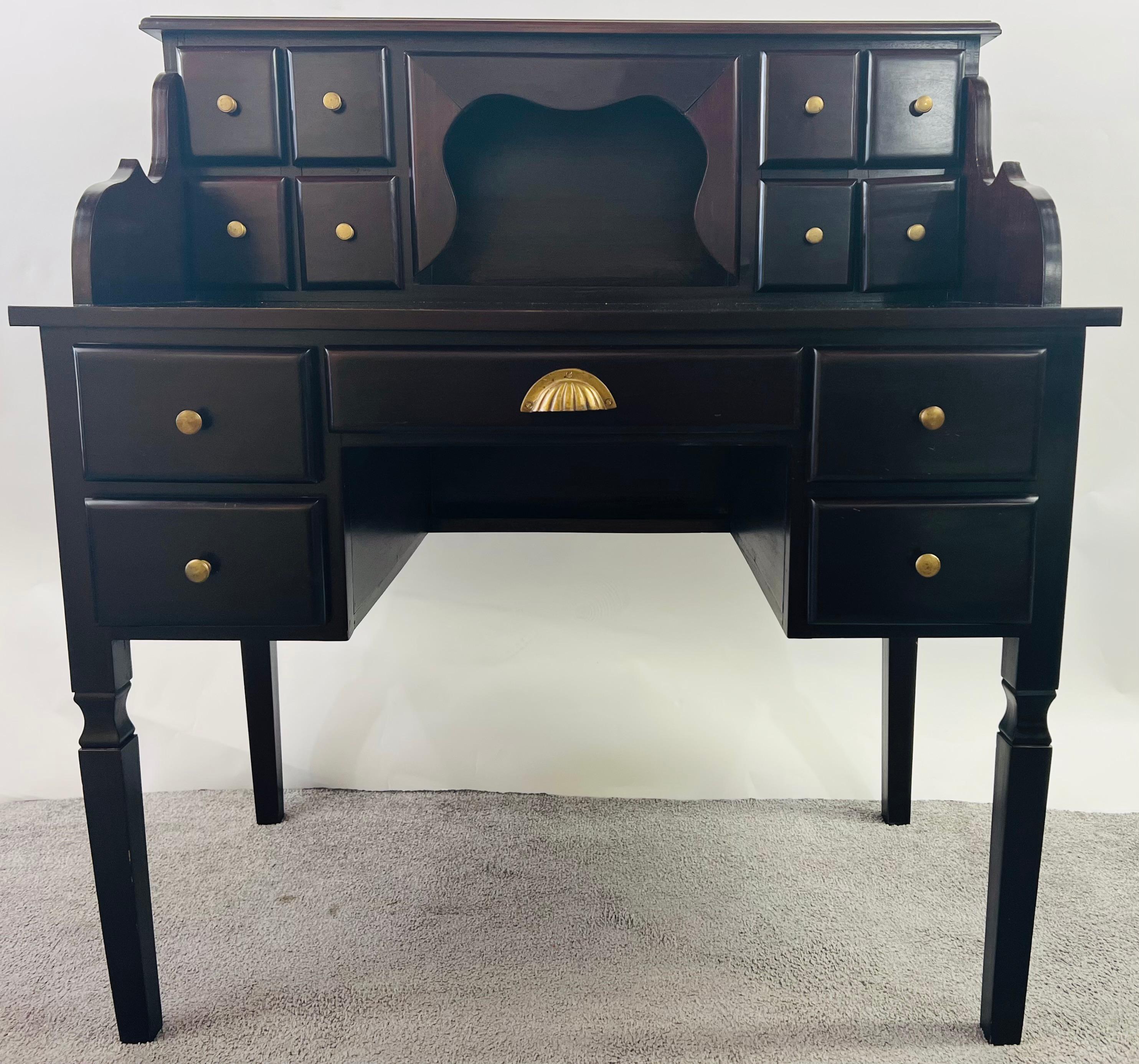 A beautiful and timeless 1970's American escritoire desk. The writing desk is made of solid mahogany and is sturdy. The desk shows fine carving details and offers 5 regular drawers and 8 small drawers on the top part with an additional large