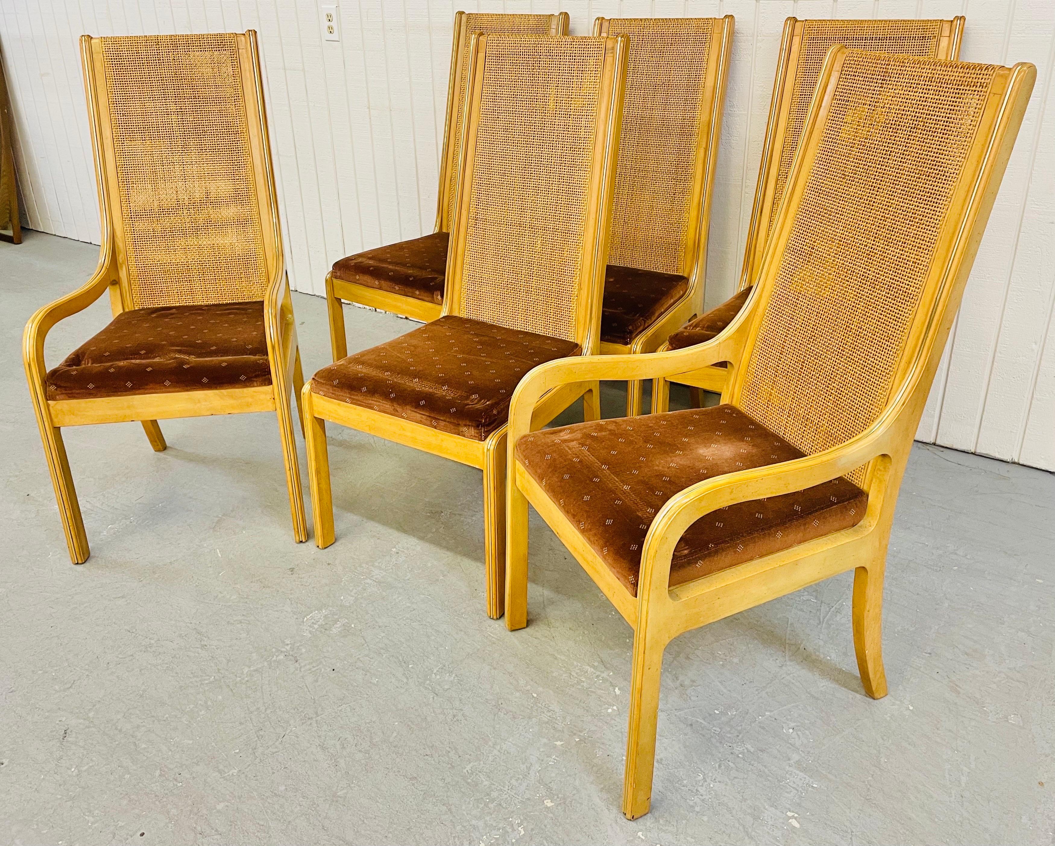 This listing is for a set of six vintage Burled wood dining chairs. Featuring two arm chairs, four straight chairs, brass accents, original upholstery, and a high back cane wrapped design.