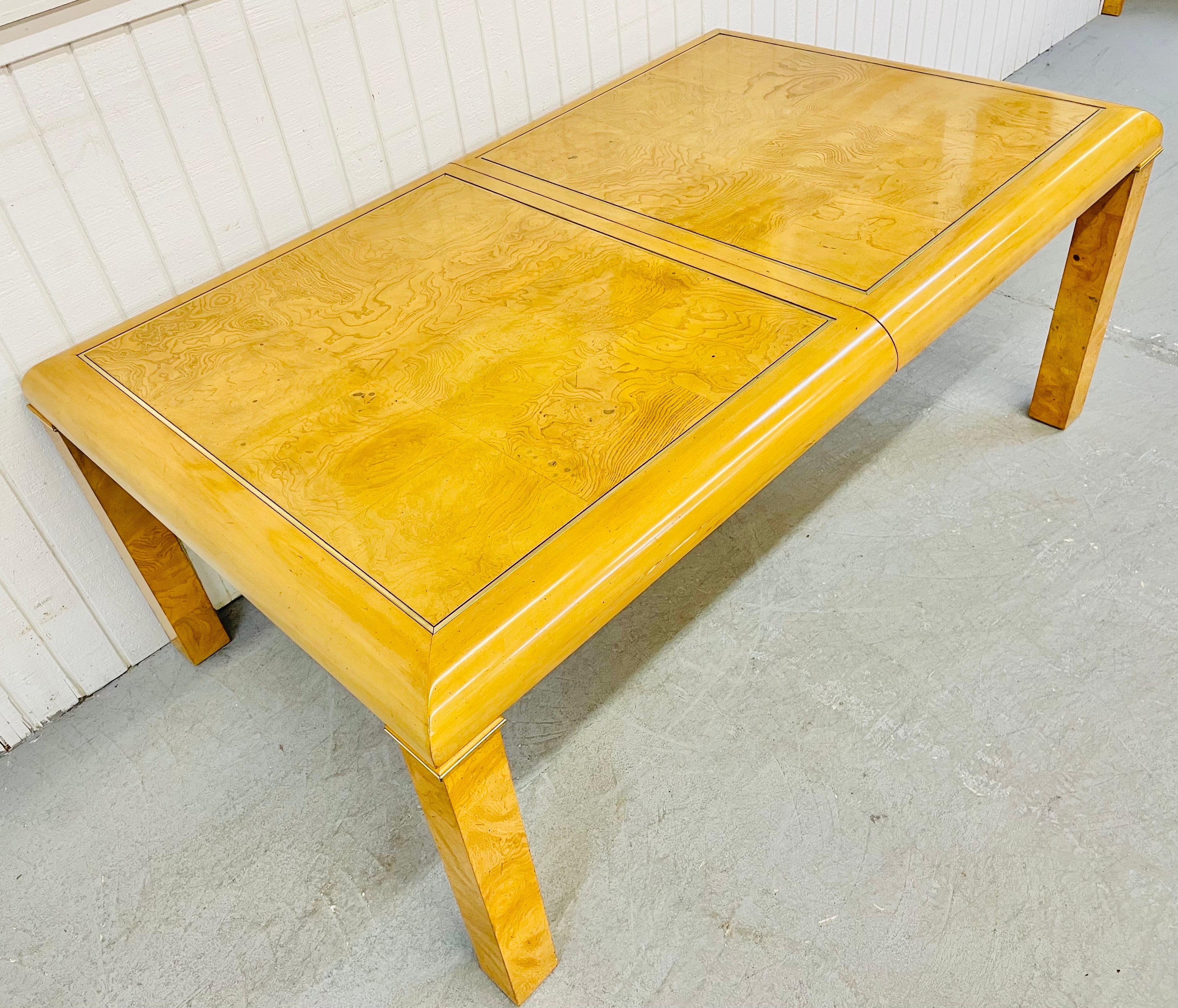 This listing is for a vintage American of Martinsville Burled Wood Dining Table. Featuring a beautiful burled wood rectangular top, brass accents, burled legs, and one leaf that extends the table up to 94” L.
