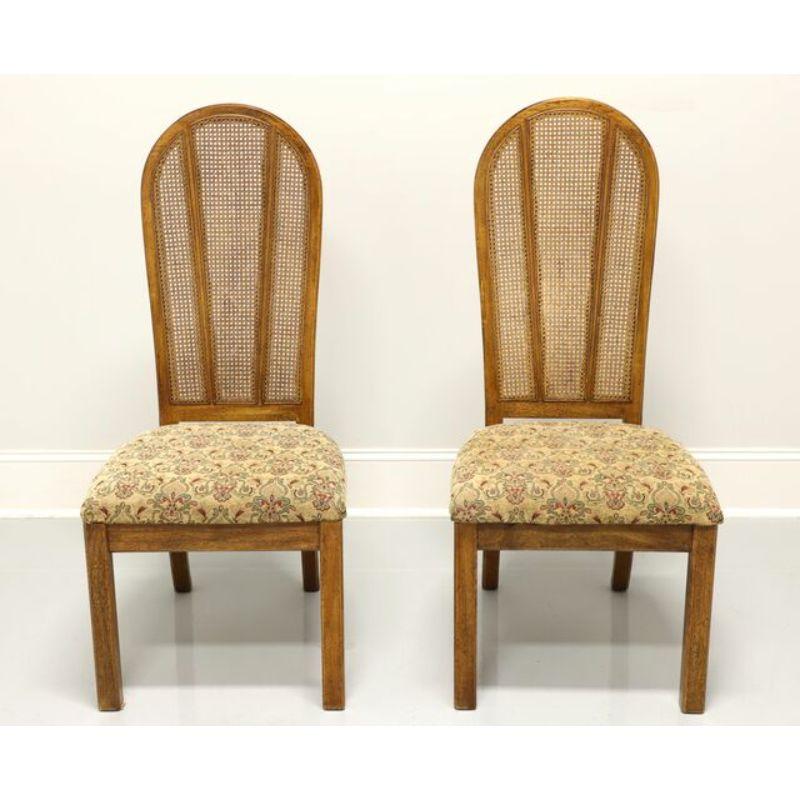 A pair of Campaign style dining side chairs by American of Martinsville. Walnut finish with rounded backs, cane back rests, earth tone color fabric upholstered seats, and straight front legs. Made in Virginia, USA, in the late 20th