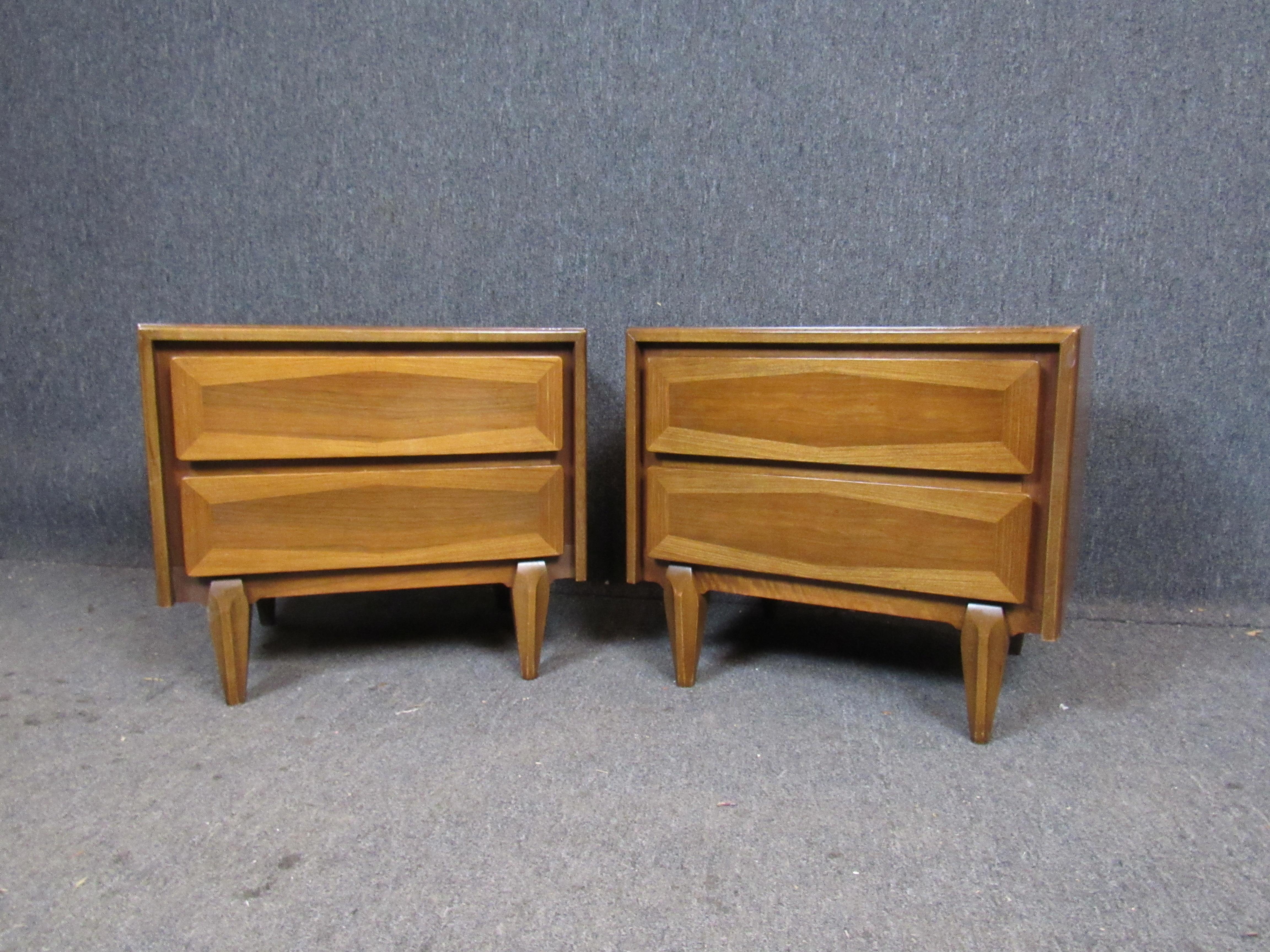 Fantastic pair of vintage night stands by the American of Martinsville furniture company. Beautifully carved legs lend an almost Primitive feel to an otherwise Classic Mid-Century Modern dual drawer design. Sure to work for a variety of uses in any
