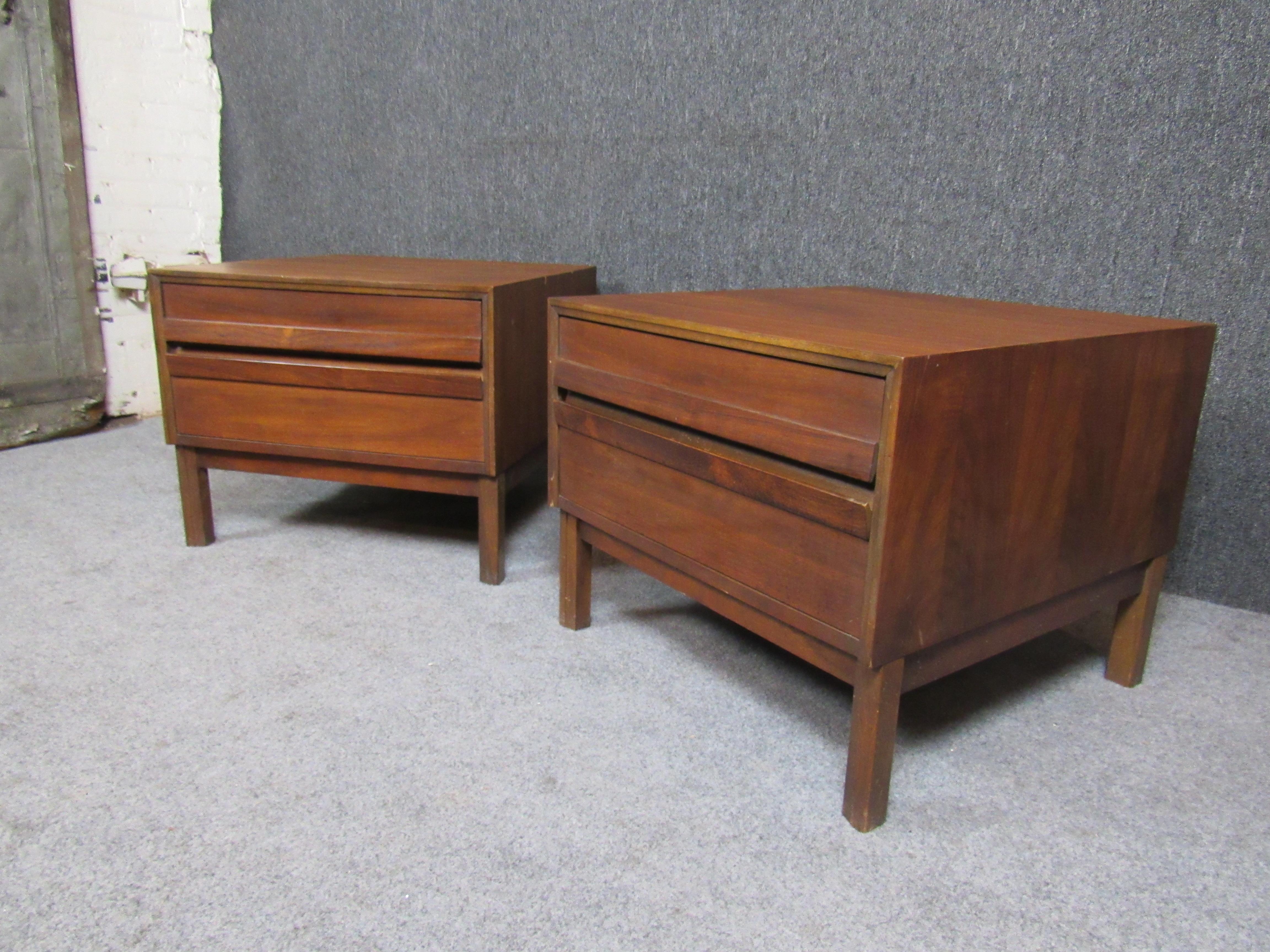 Bring home the form and function that has put mid-century modern at the top of the furniture world! Sleek, yet robust, these walnut end tables feature a rich warm wood grain and ample tops. A pair of large drawers creates plentiful storage