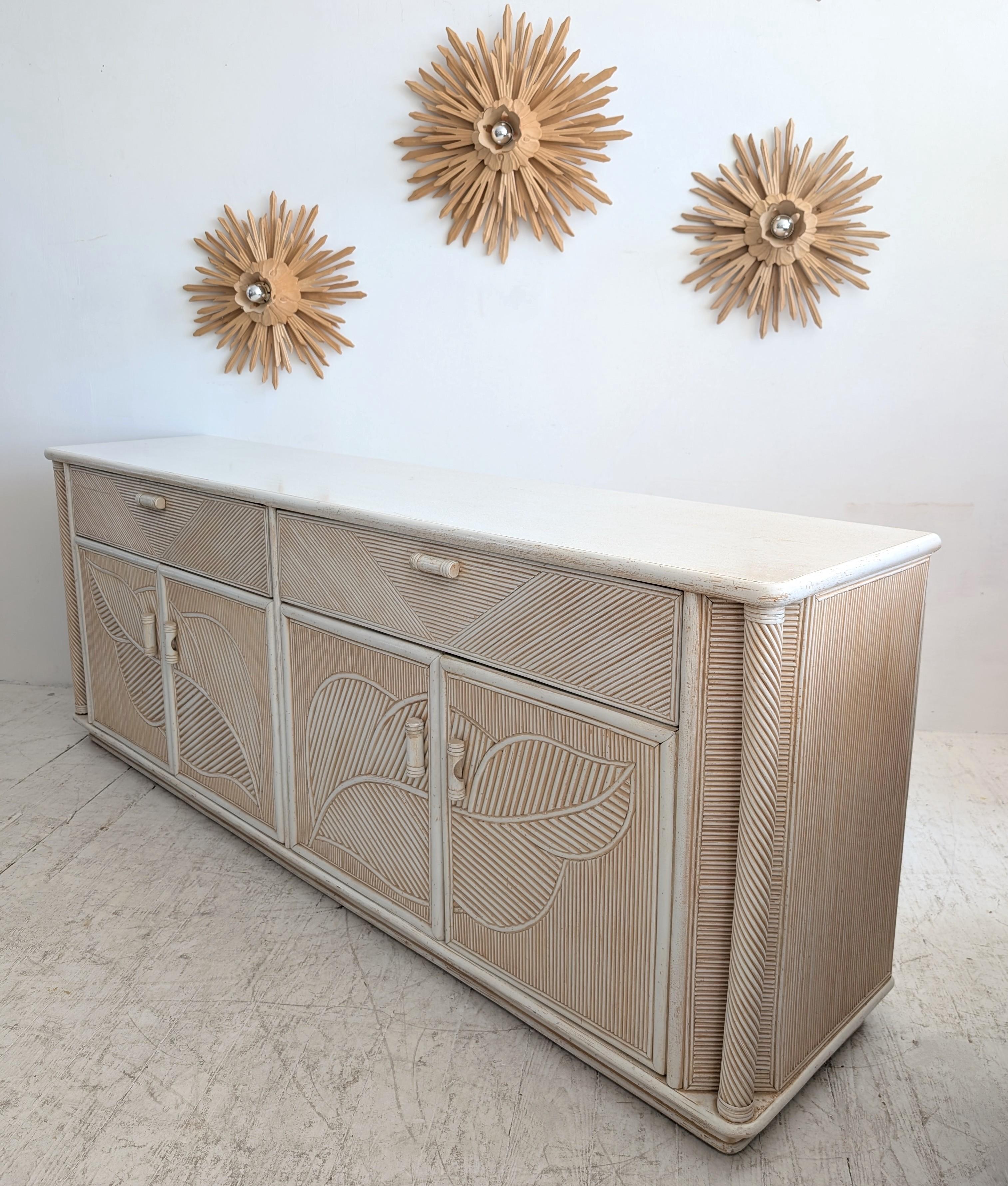 Vintage pencil reed & wood sideboard with leaf motif, USA 1970s. Two large drawers on top; two shelves storage cupboards below. Has an aged patina paint/lacquer finish to give some character and depth.

A lovely neutral piece for lounge or