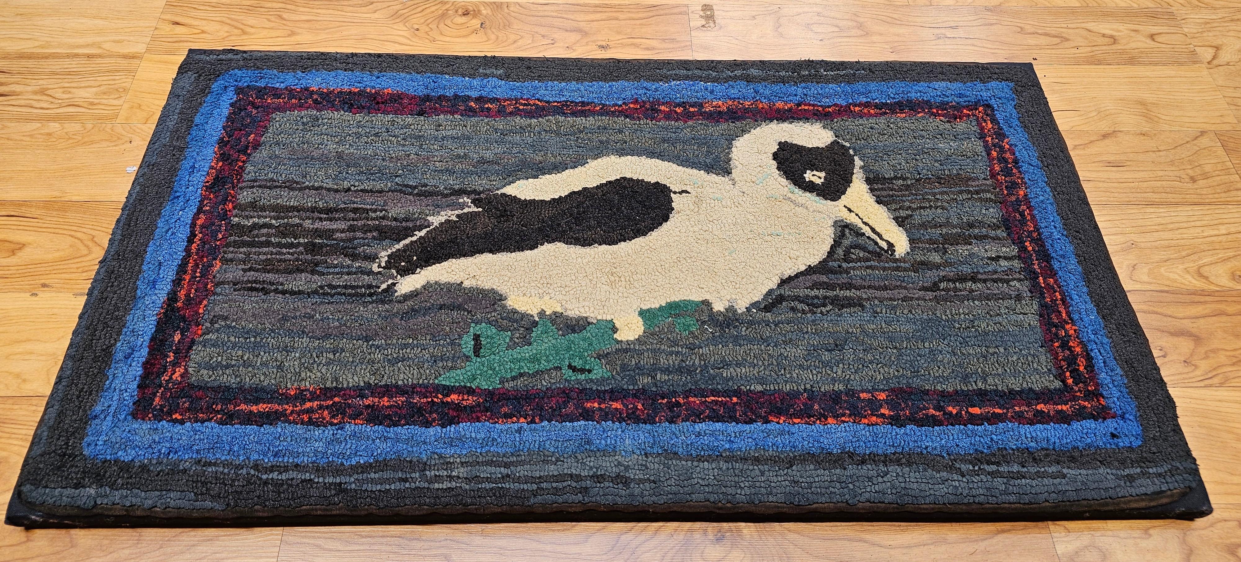 Vintage American hand hooked rug in a wonderful depiction of a Dodo bird mounted on a frame.  The Dodo is an extinct flightless bird that was endemic to the island of Mauritius, which is east of Madagascar in the Indian Ocean.   The rug has a