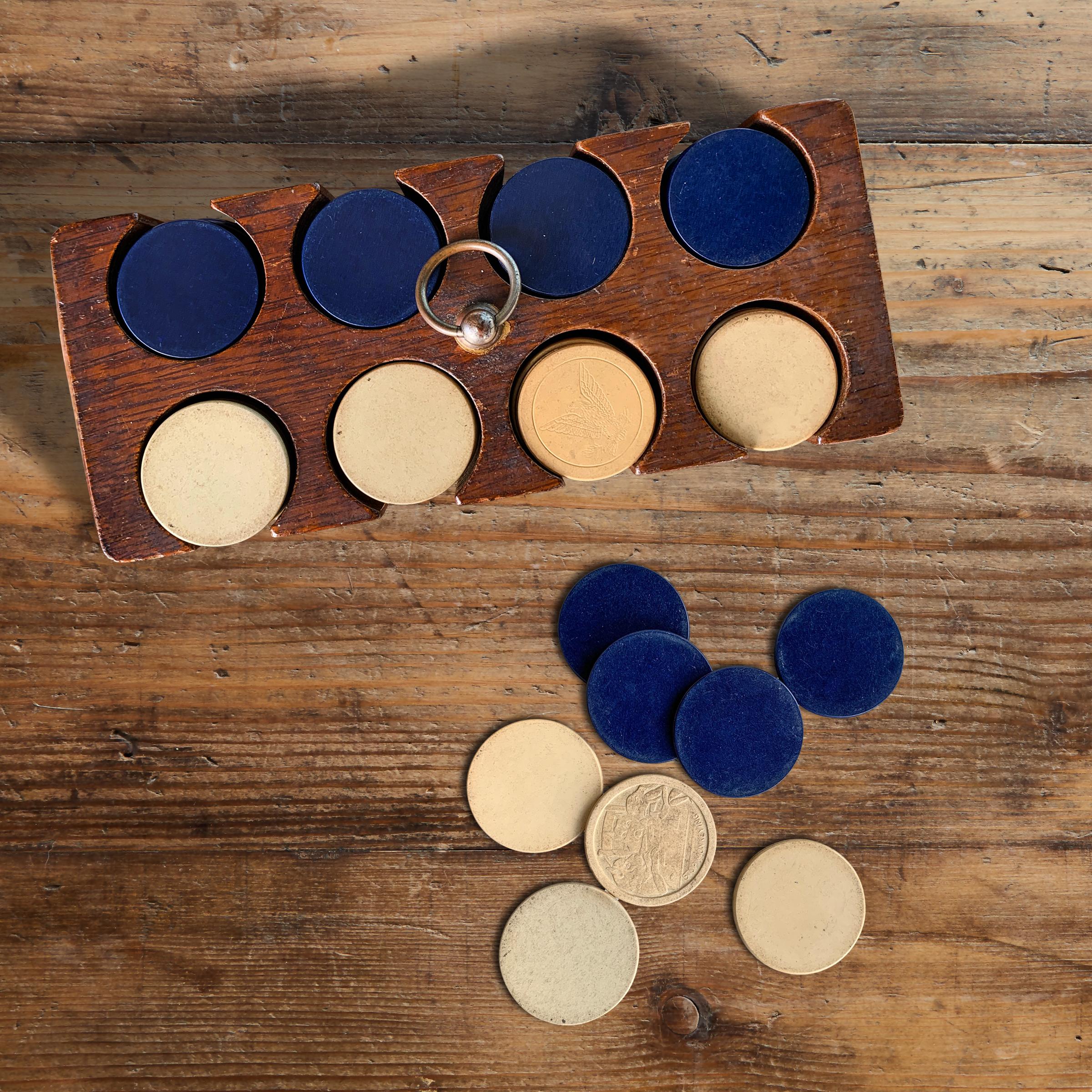 Ante up! A fun and playful set of vintage American clay poker chips, white and blue, with several being stamped with dogs playing poker, and other whimsical images. Chips are housed in an oak caddy with a brass ring pull. There are 108 chips of each