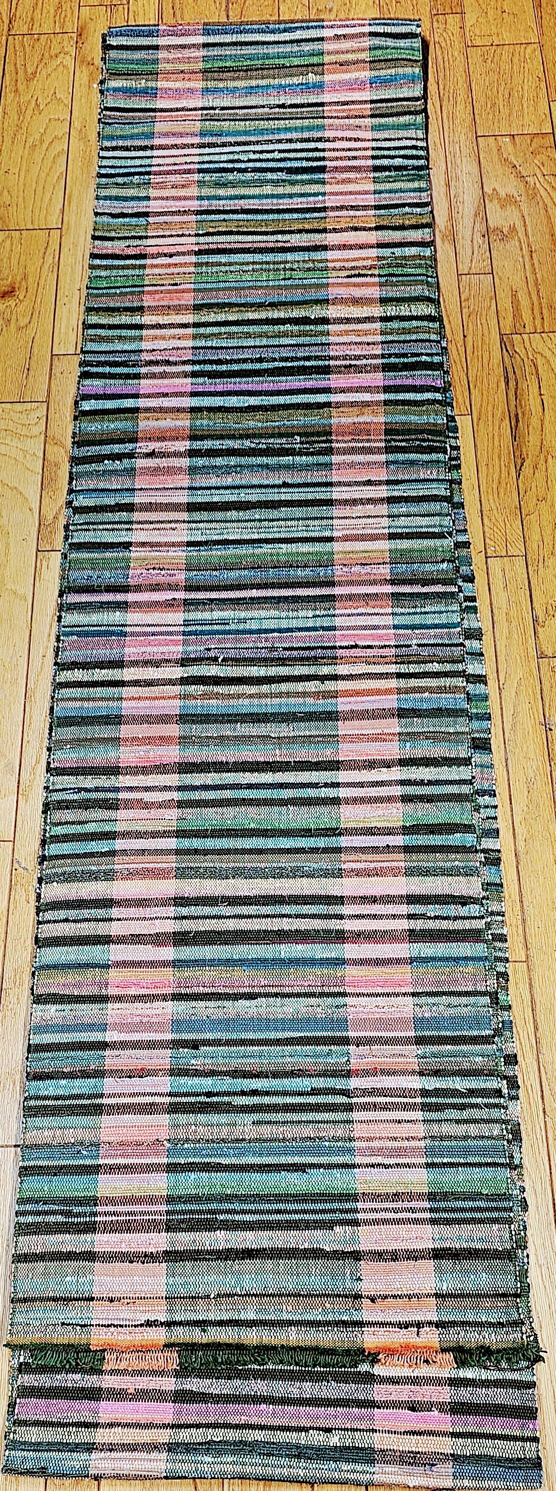 Vintage American rag runner has a green color field and two sets of stripes in beautiful pink color variations. Custom resizing service is available for this item upon request.  The long rag runner can be custom made into various size runners and