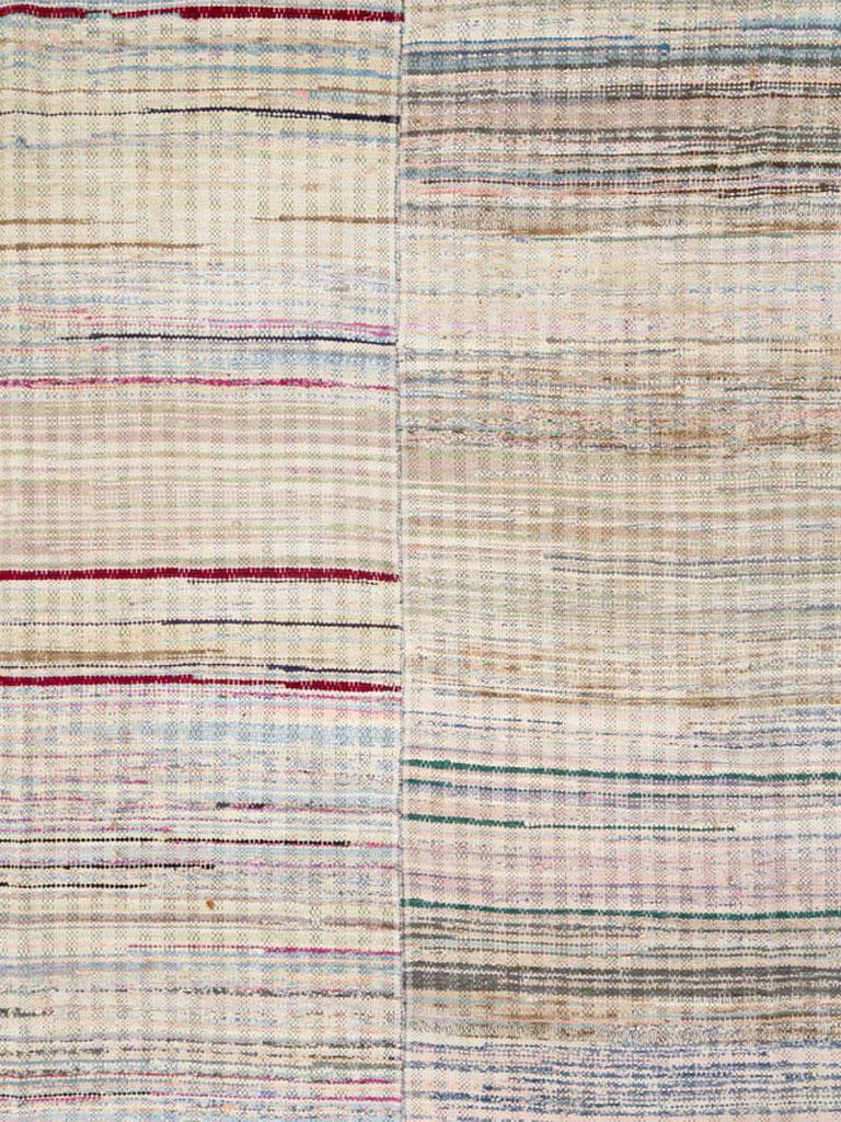 A vintage American Rag rug from the mid-20th century. Four independent vertical rag sections compose this borderless, ever varying rag carpet. The rags differ in each strip, hence literally many hundred rags, almost all from garments, were used to