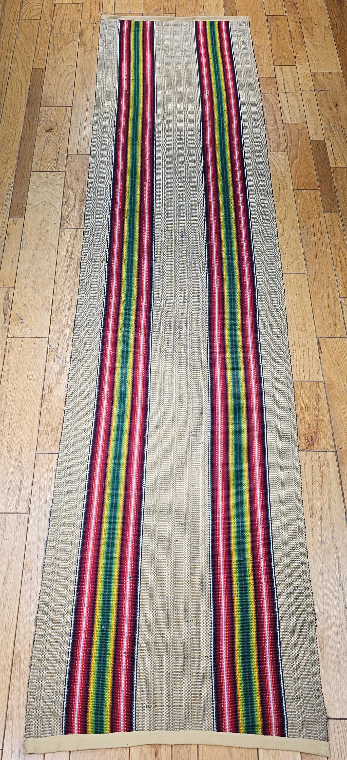 Vintage American rag runner from the early 1900s in a wonderful modern design pattern and a rainbow of brilliant colors.  The design of this early 20th century American rag runner consists of two multicolor wide bands in bright shades of green,