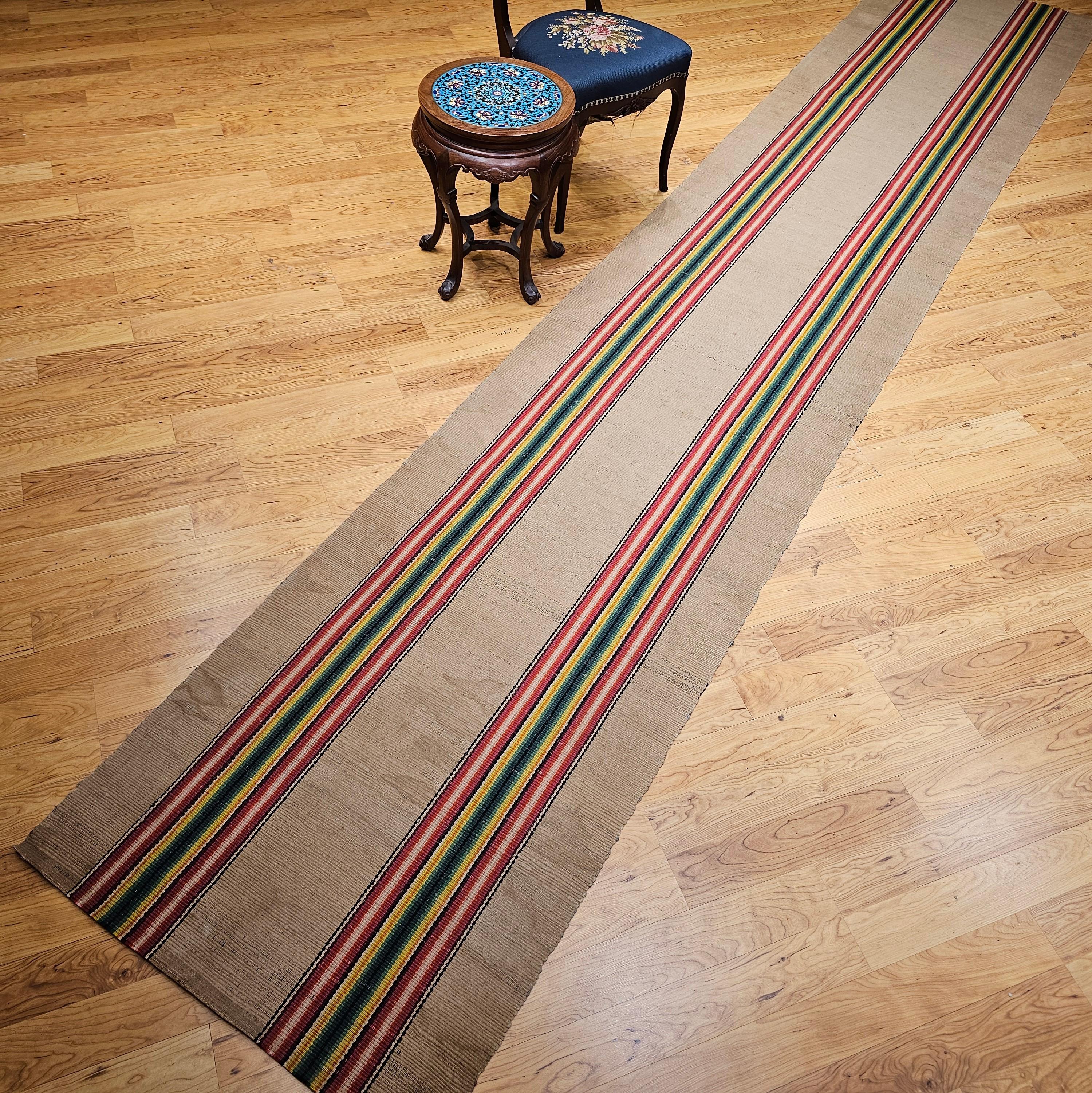 Vintage American rag runner from the early 1900s in a wonderful modern design pattern and a rainbow of brilliant colors.  The design of this early 20th century American rag runner consists of two multicolor wide bands in bright shades of green,