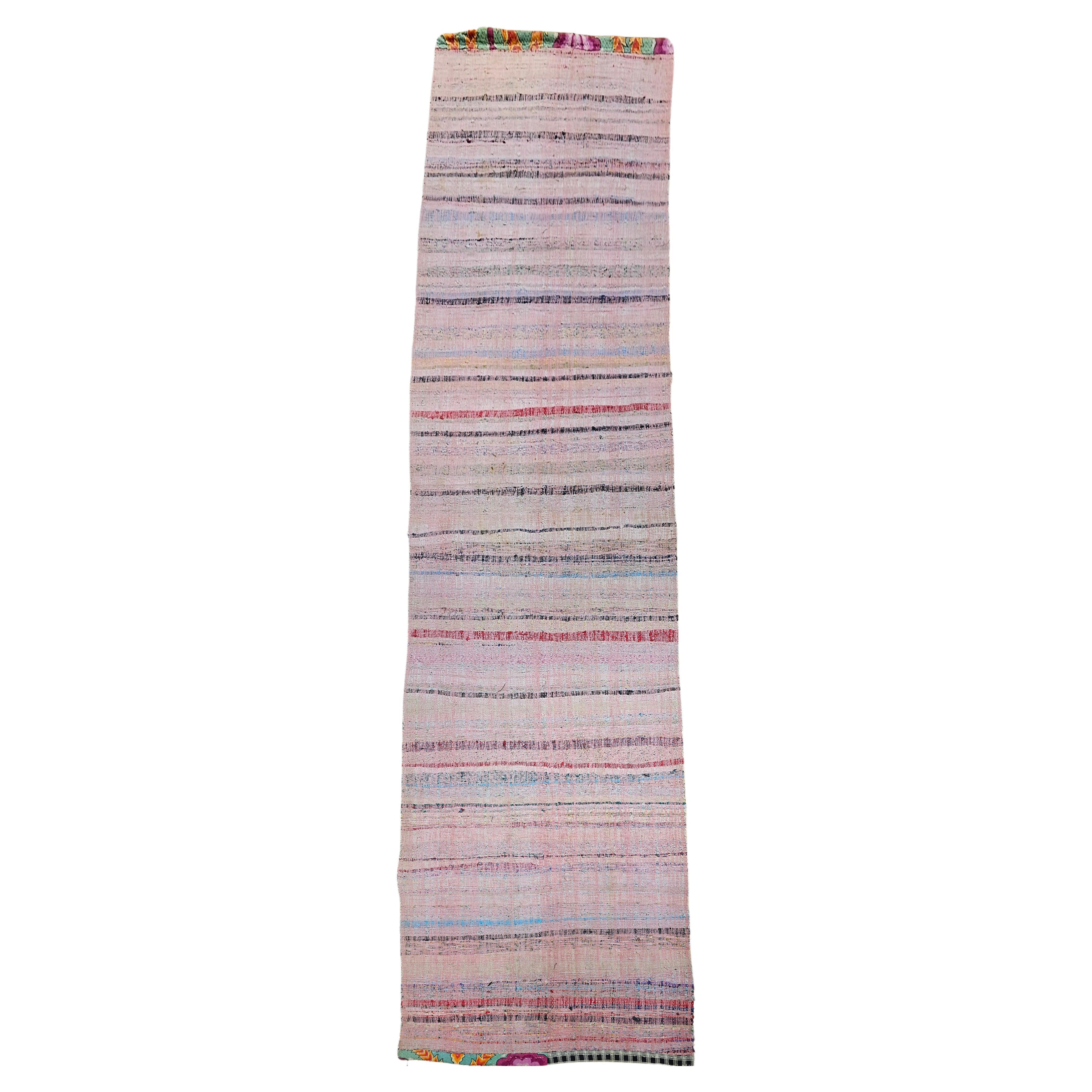 A beautiful and colorful vintage American Rag Runner (flat-woven) runner in stripe pattern with a beautiful combination of colors including pink, green, blue, red and yellow.  The runner is in a wide and long format.  This runner's end has been