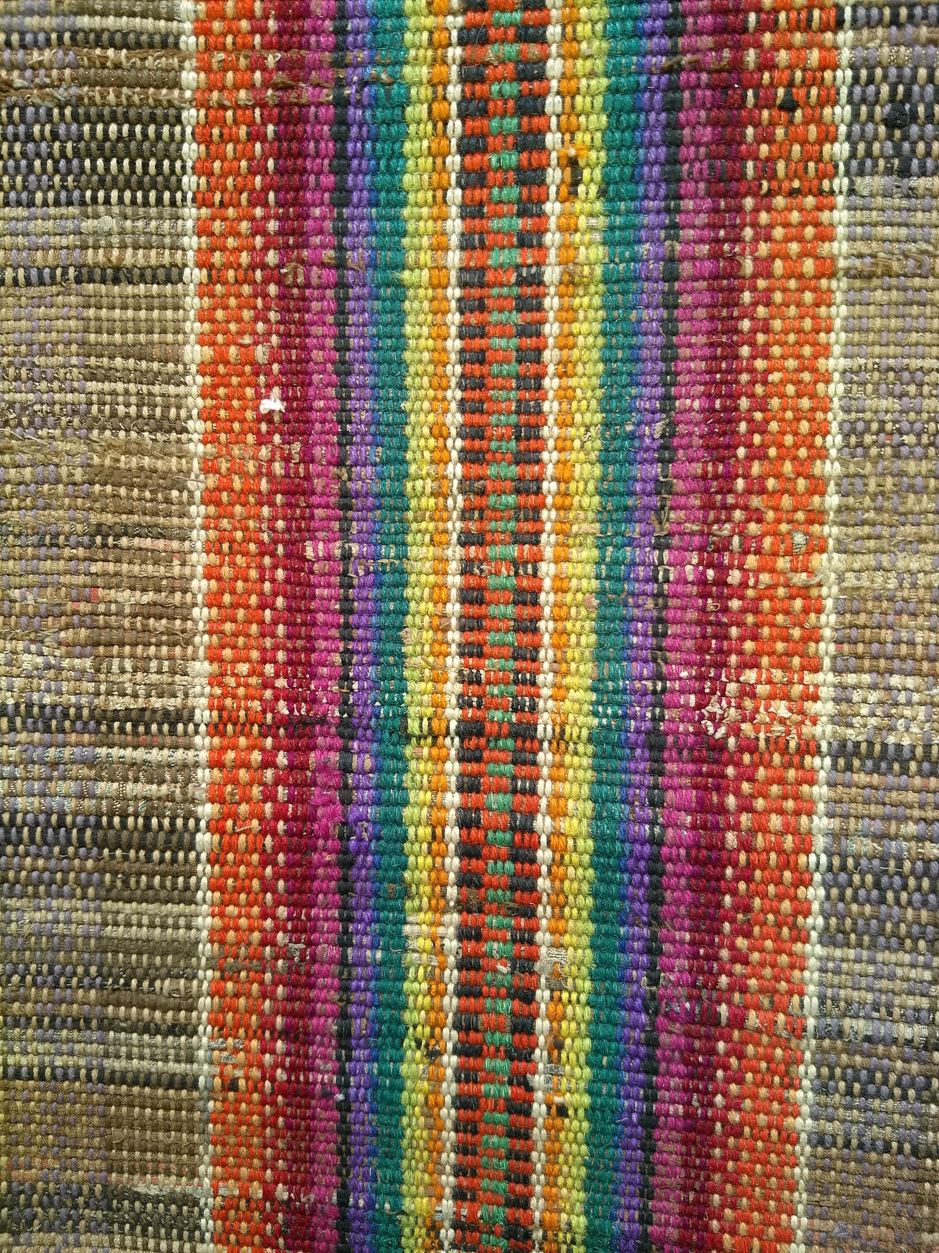 The vintage American rag runner in straw color with a rainbow colored stripe pattern in the center.  The hand-woven rag runner has a very modern design format and can be incorporated into any modern interior design project.  The rag runner can be