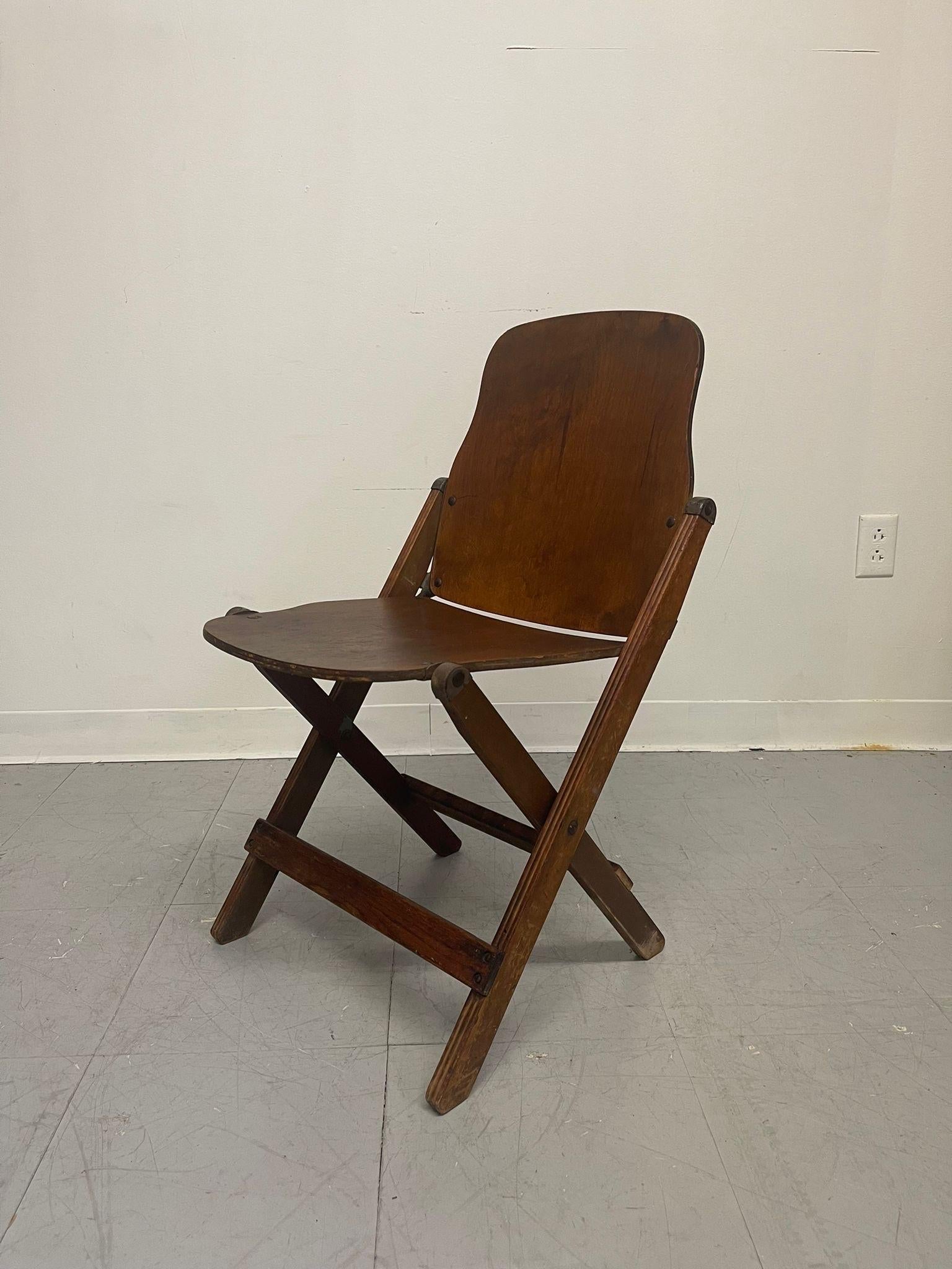 Vintage Wooden Folding. American Seating Company on the Seat as Pictured.Slight Chipping on the Back. Vintage Condition Consistent with Age as Pictured.

Dimensions. 21 W ; 17 D ; 30!H