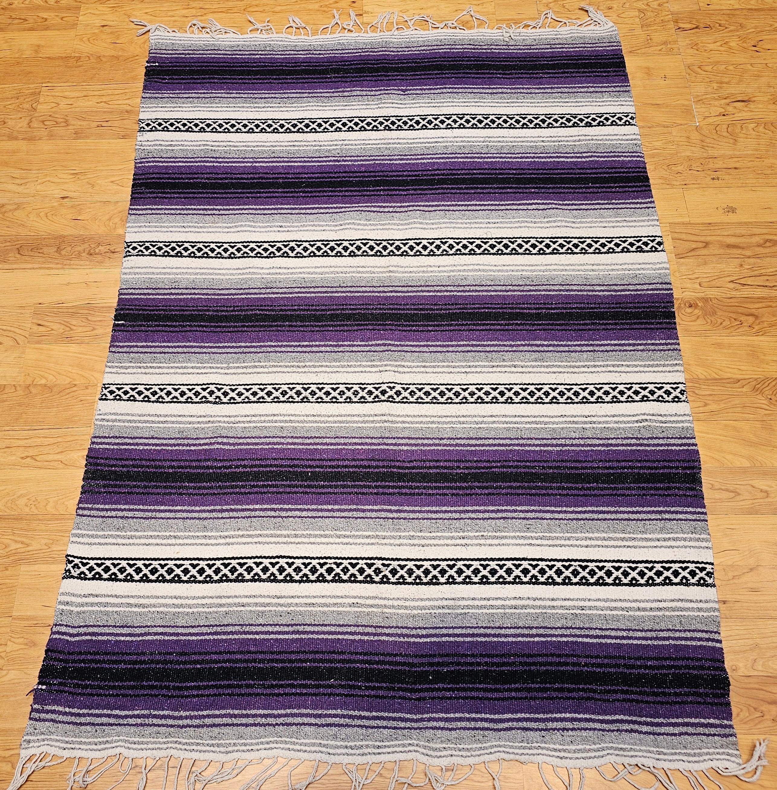 Add vibrant character and heritage charm to your space with this vintage American Southwestern kilim rug, featuring a dynamic alternating wide and narrow stripe pattern accented by narrow geometric bands. Handwoven in a brilliant palette of