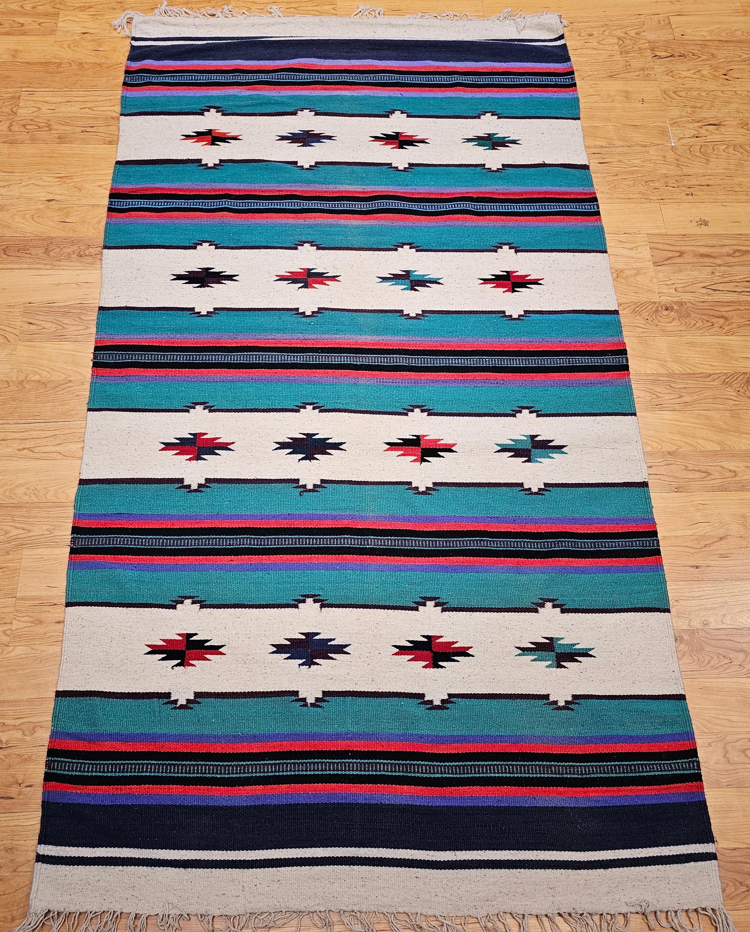 Ce tapis kilim vintage du sud-ouest, qui fait partie de notre Collection Americana, présente un design audacieux et équilibré avec une alternance de larges bandes ivoire et vertes, séparées par d'étroites bandes multicolores en rouge, lavande et