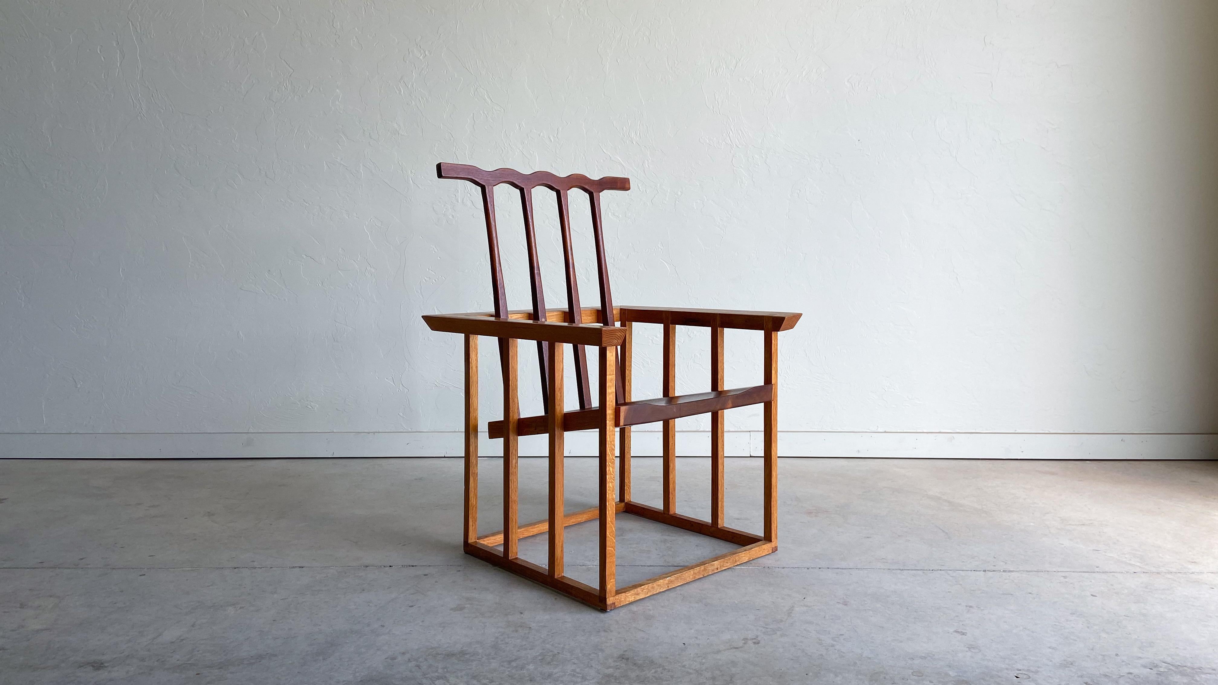 Offered is a well executed studio craft high back armchair made from solid oak and walnut. Constructed without hardware, using only dowel and lap joinery. 

A unique chair that is mostly geometric in design, but complimented by an almost whimsical