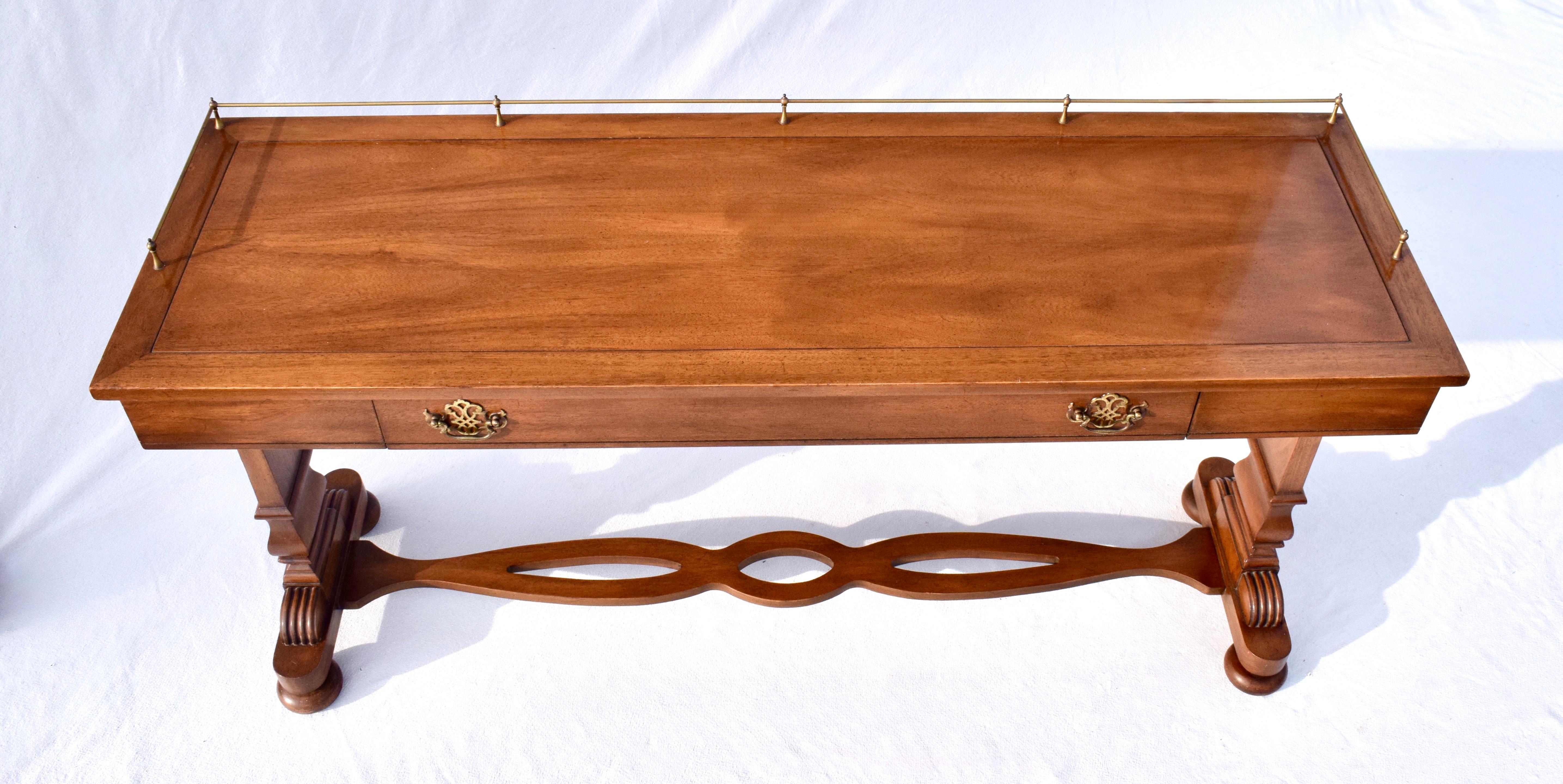 An elegant single drawer Walnut console table with brass gallery, new custom glass top boasting elegant aesthetics  & Transitional practicality.