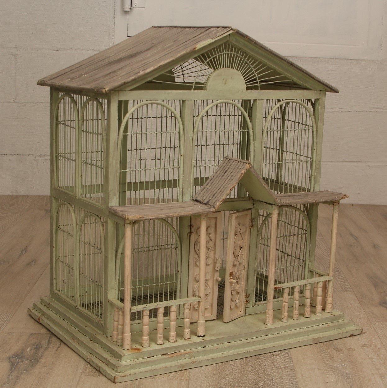 A handmade wooden birdhouse made in a 19th century American vernacular style.

USA, circa 1950.

Age related wear and vintage charm.

Dimensions: 24” L x 18” W x 26” H
