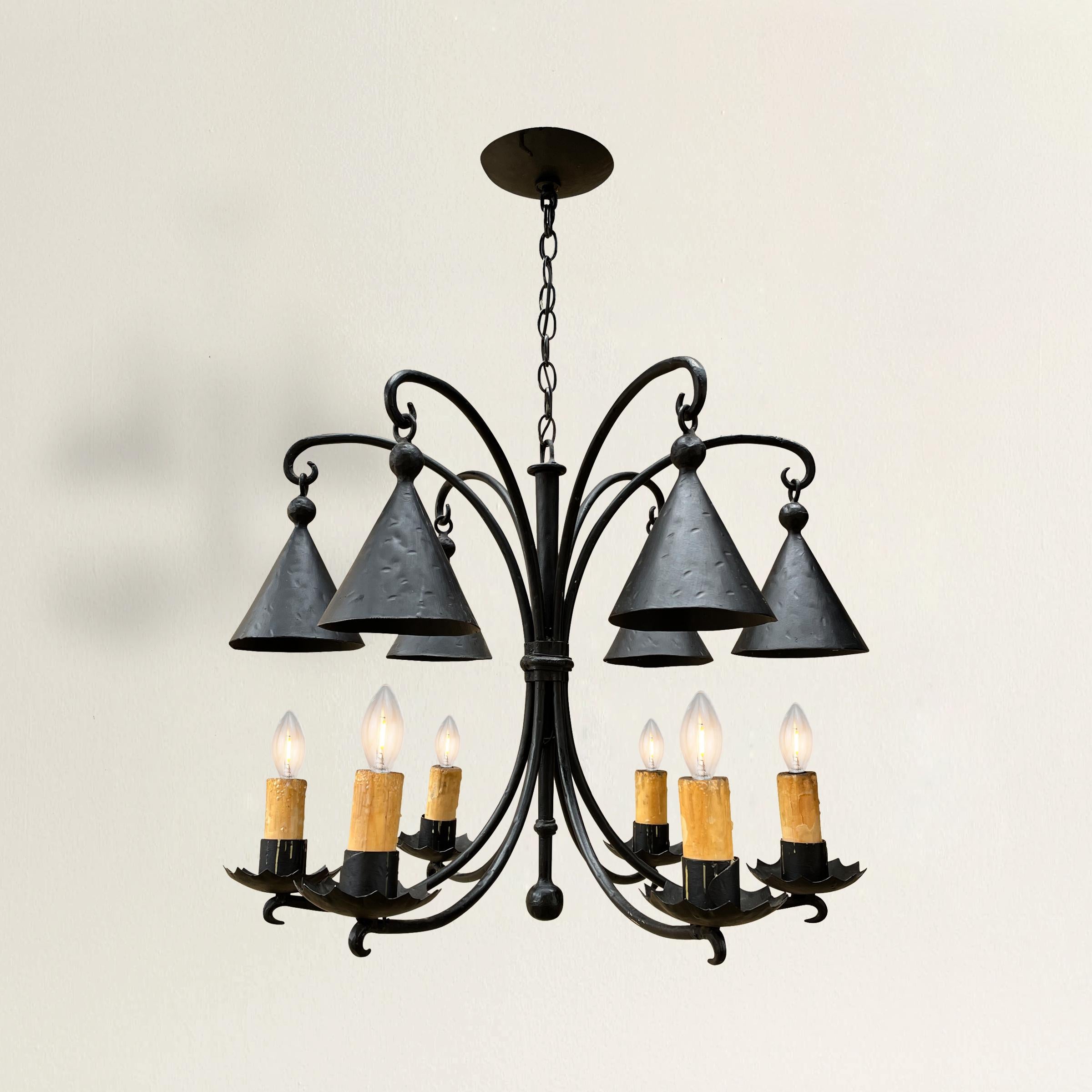 A wonderfully charming vintage American wrought-iron six-arm chandelier with removable cones that hang from hooks, and each candle cup with scalloped edges. Wired for US. Candelabra base bulbs required.