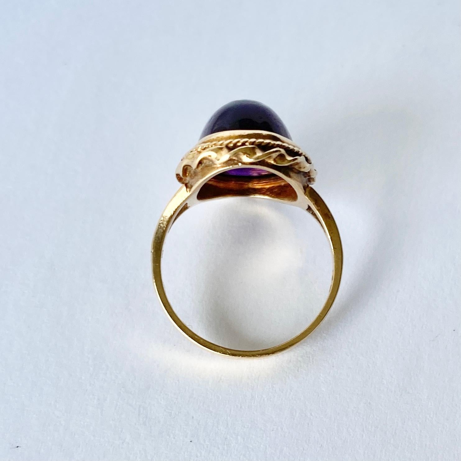 This glossy and bright purple amethyst stone is surrounded by a frame of thick and thin twists of gold. Modelled in 9ct gold and made in Chester, England. 

Ring Size: L 1/2 or 6 
Stone Dimensions: 14x10mm 

Weight: 4g