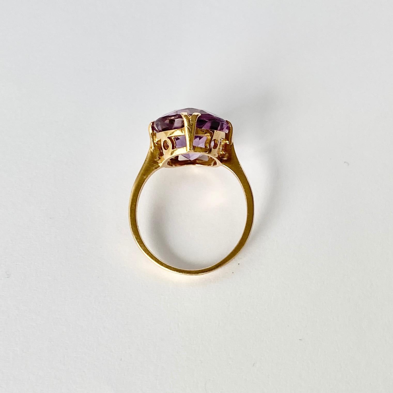 This glossy and bright purple amethyst stone is surrounded by a frame of delicate claws. Fully hallmarked London 1962. 

Ring Size: N or 6 3/4
Stone Dimensions: 12x15mm 

Weight: 3.6g