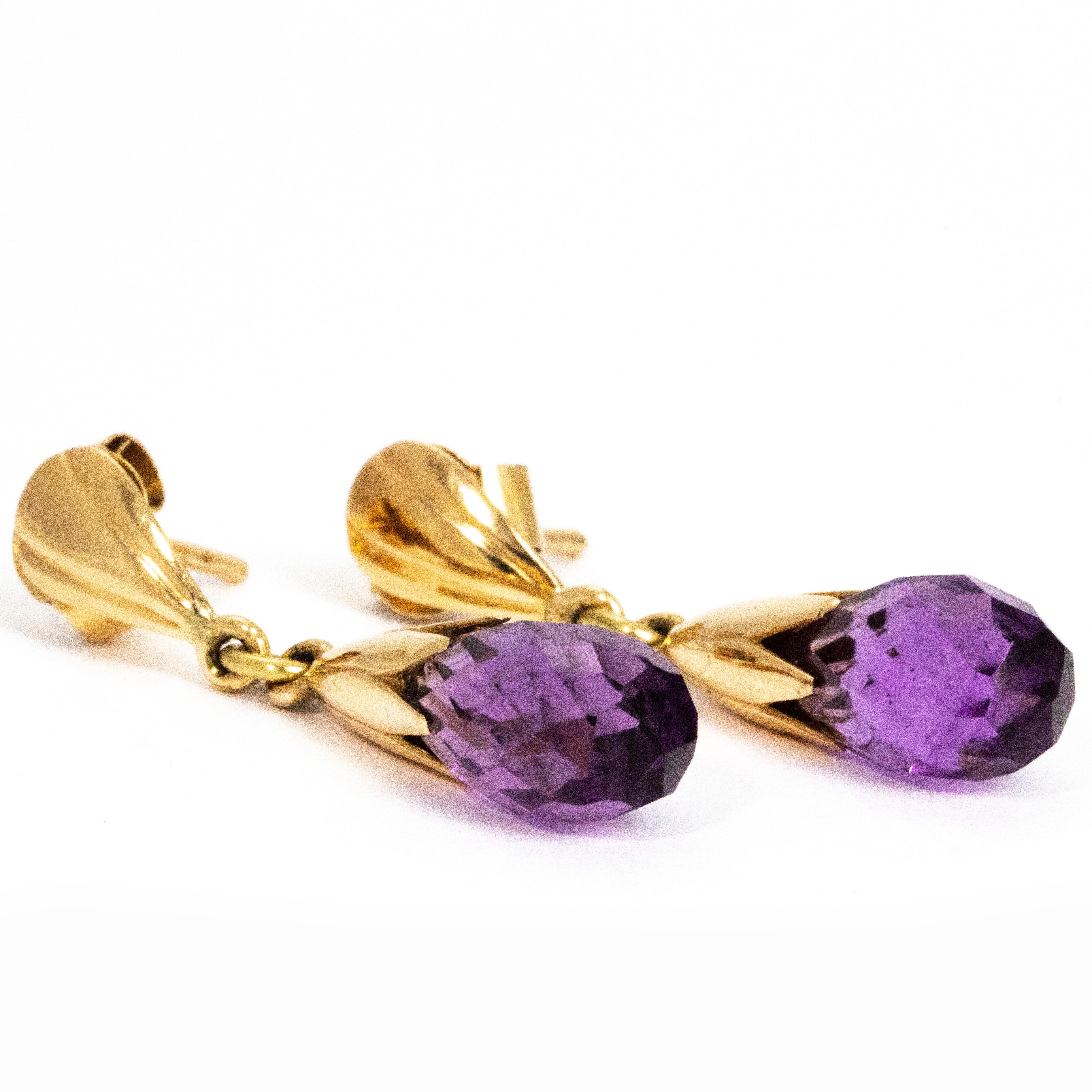 The way these drop earrings glisten in the light is stunning. The bright purple amethyst is such a gorgeous colour and is complemented by the glossy gold. The scalloped stud that holds the amethyst add a lovely bit of detail. 

Drop Length: 32mm