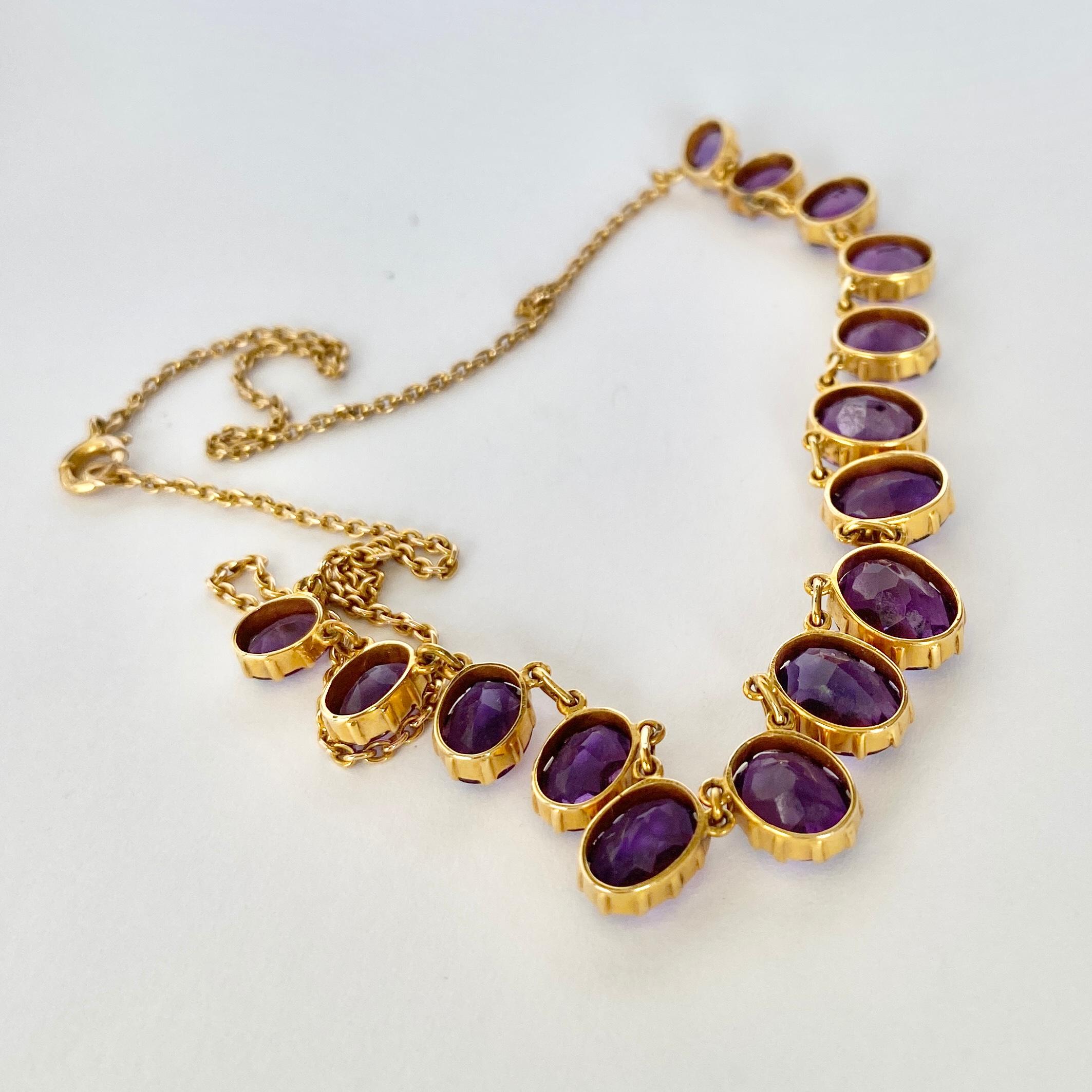 Fifteen stunning bright purple amethyst stones adorn this necklace. The largest stone measures 10x8mm and the smallest goes down to 6x4.5mm. The 15ct gold chains delicate compared to the chunky stones and is fastened using a classic bolt