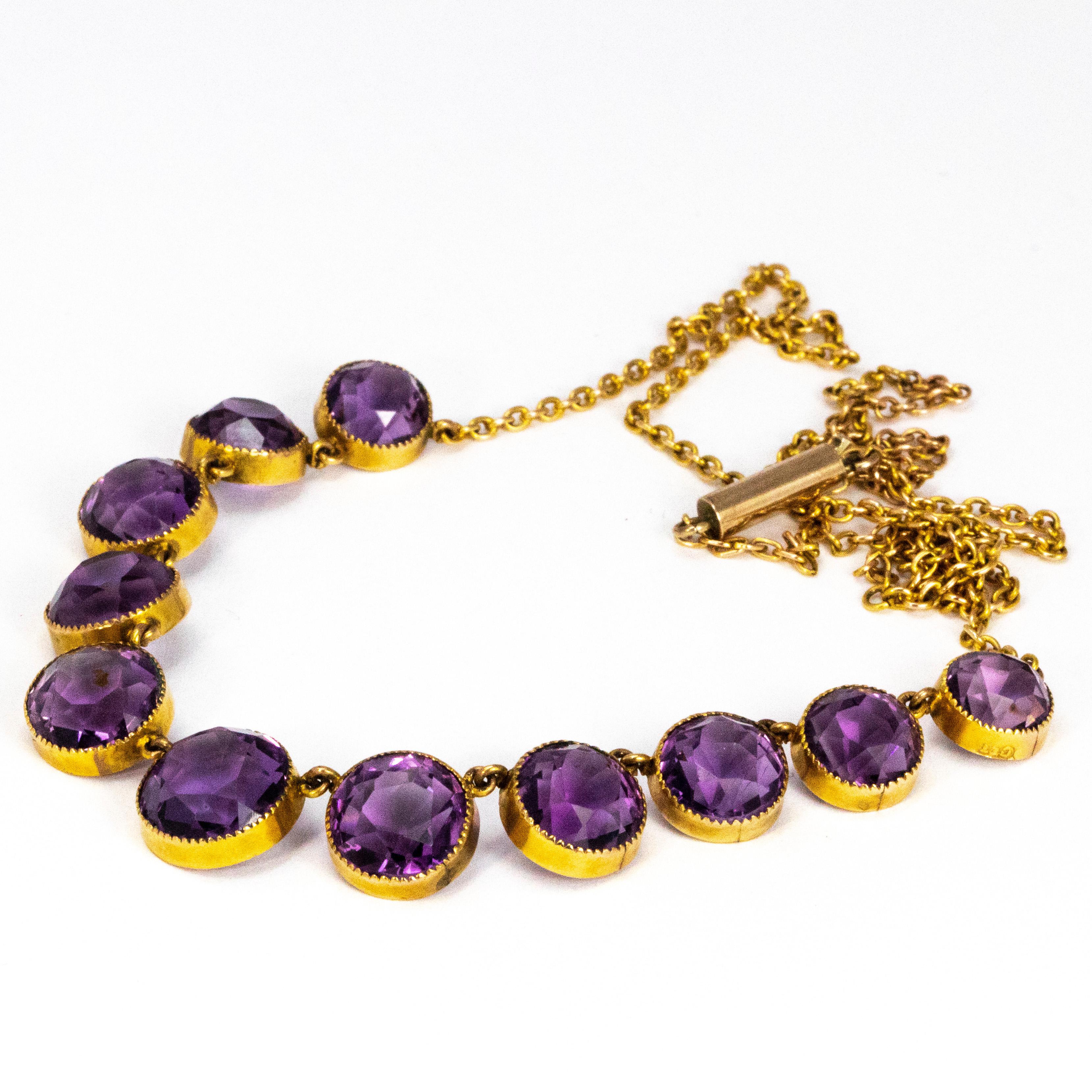 Eleven stunning bright purple amethyst stones adorn this necklace. The largest stone measures 10mm in diameter and the smallest goes down to 7.5mm. The 9ct gold chains delicate compared to the chunky stones and is fastened using a barrel