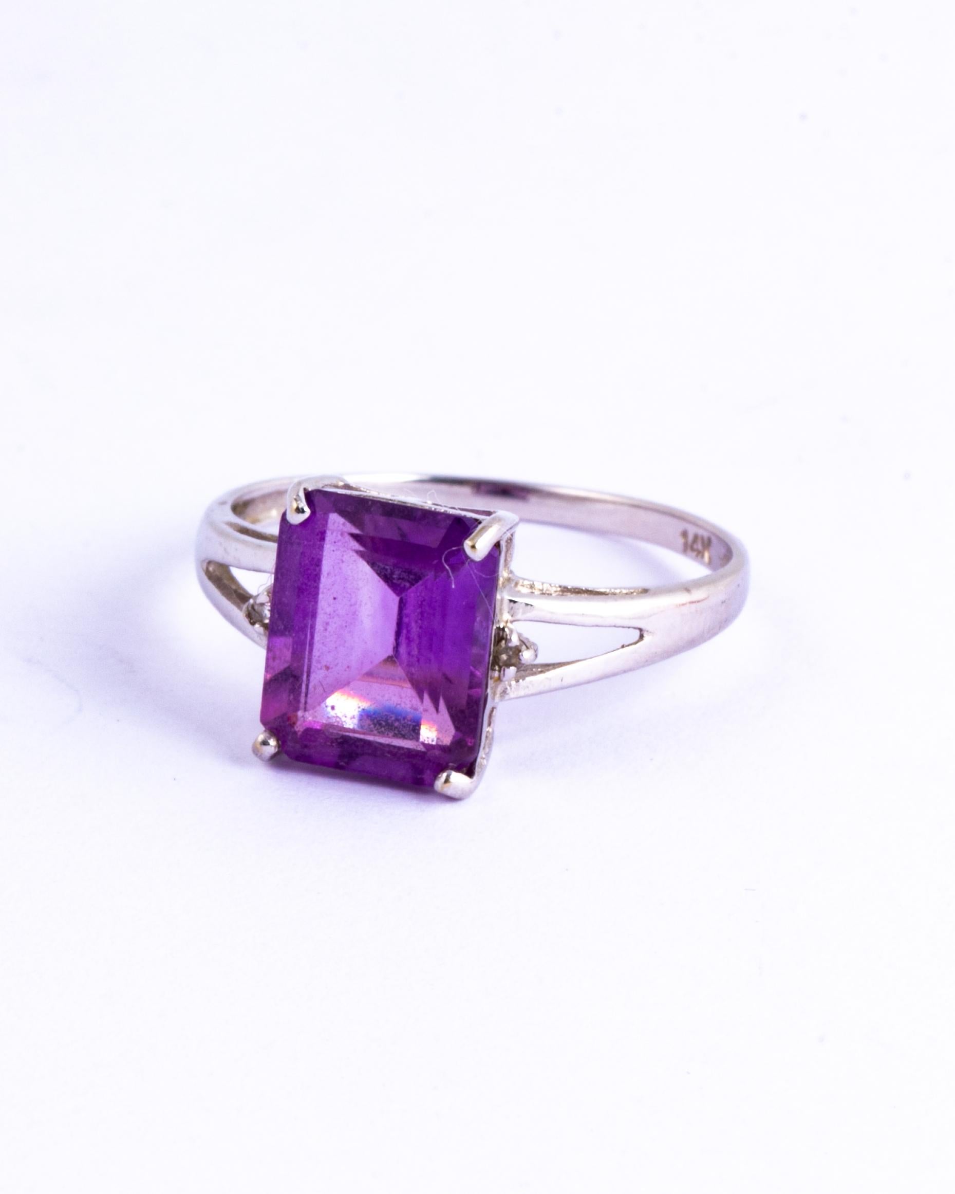 This gorgeous amethyst stone is bright purple and reflects the light in a beautiful way. Either side of the central stone there are single diamond points. 

Ring Size: O 1/2 or 7 1/2 
Stone Dimensions: 8x9mm 

Weight: 1.7g