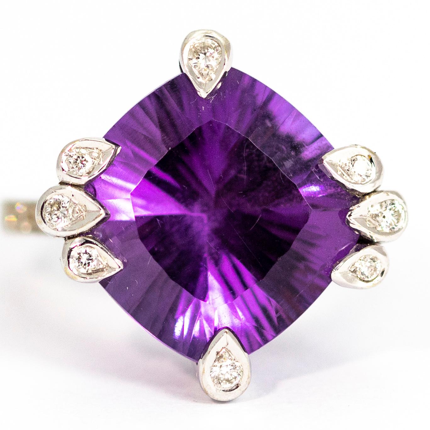 This ring is sure to get you noticed! It holds a large glittering amethyst has a stunning hall of mirrors effect and the claws which hold the stone each hold a sparkling diamond too! The shoulders to this ring also hold a row of five diamonds each